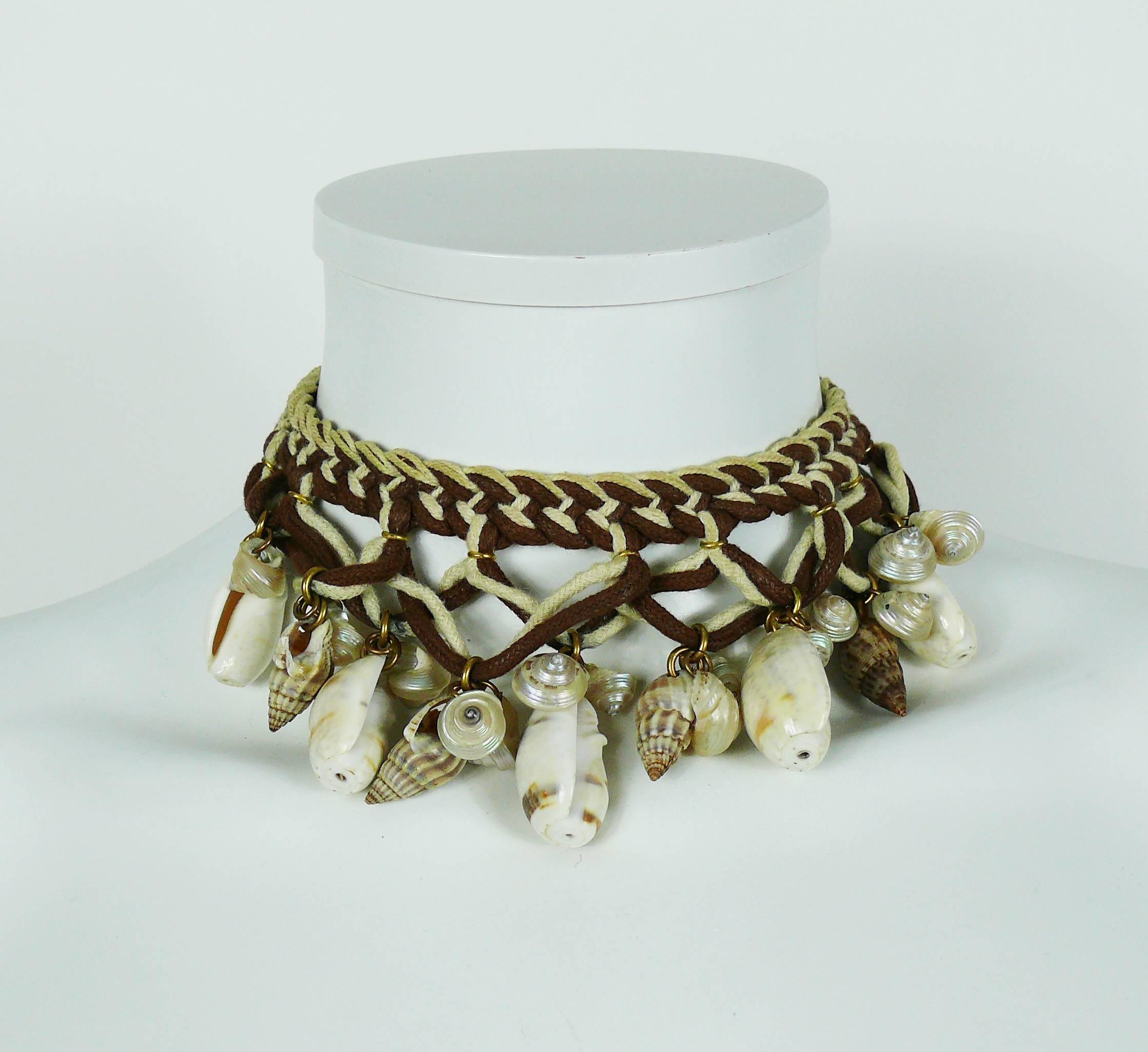 YVES SAINT LAURENT vintage rare African tribal inspired braided cord necklace embellished with shells.

Probably designed by LOULOU DE LA FALAISE for YVES SAINT LAURENT.

Embossed YSL.

Indicative measurements : length approx. 33 cm (12.99