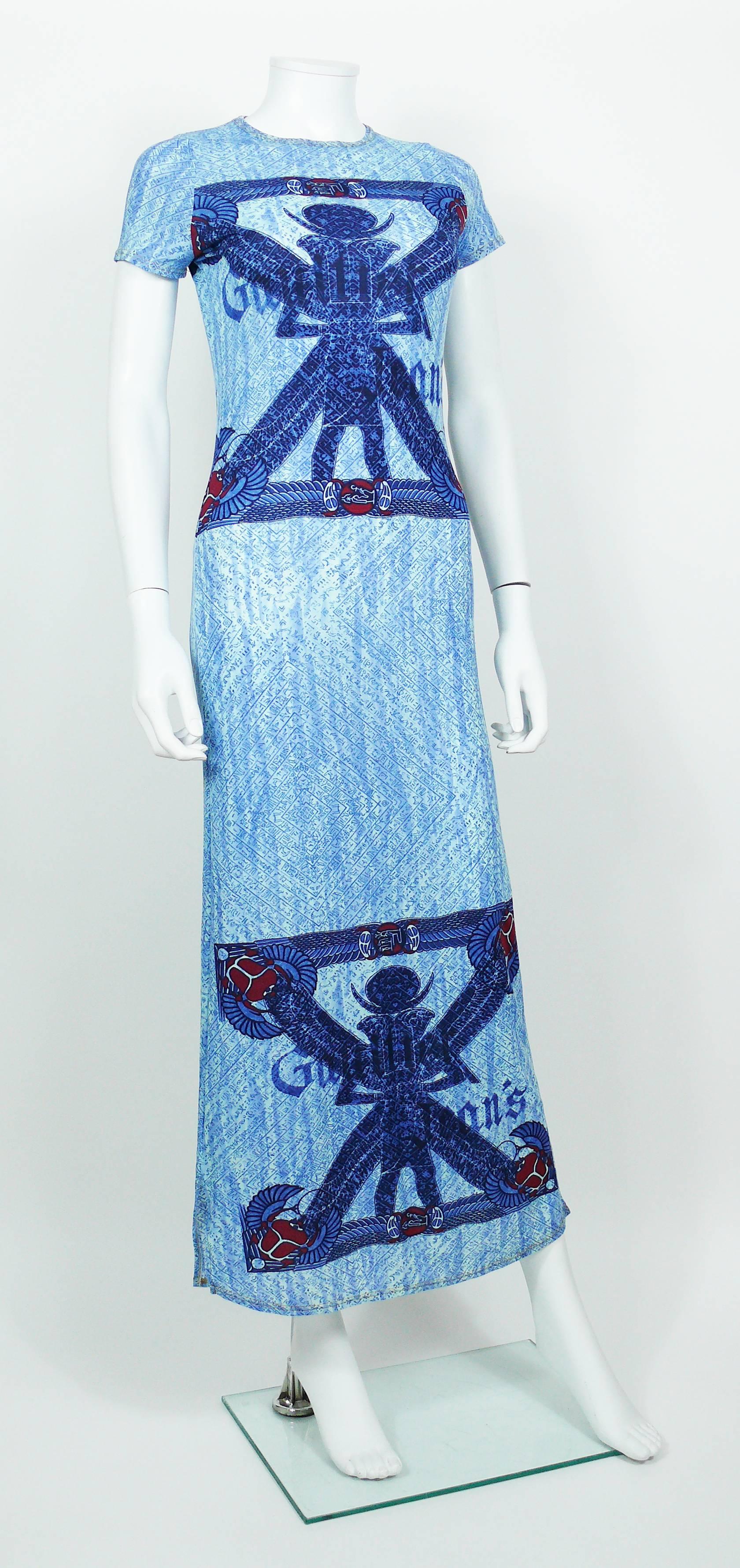 JEAN PAUL GAULTIER vintage blue maxi dress featuring Egyptian hieroglyphs and scarab motifs printed throughout.

This dress features :
- Stretchy material.
- Round collar.
- Cap sleeves.
- Slits on both sides.

Label reads GAULTIER JEAN'S.

Size tag