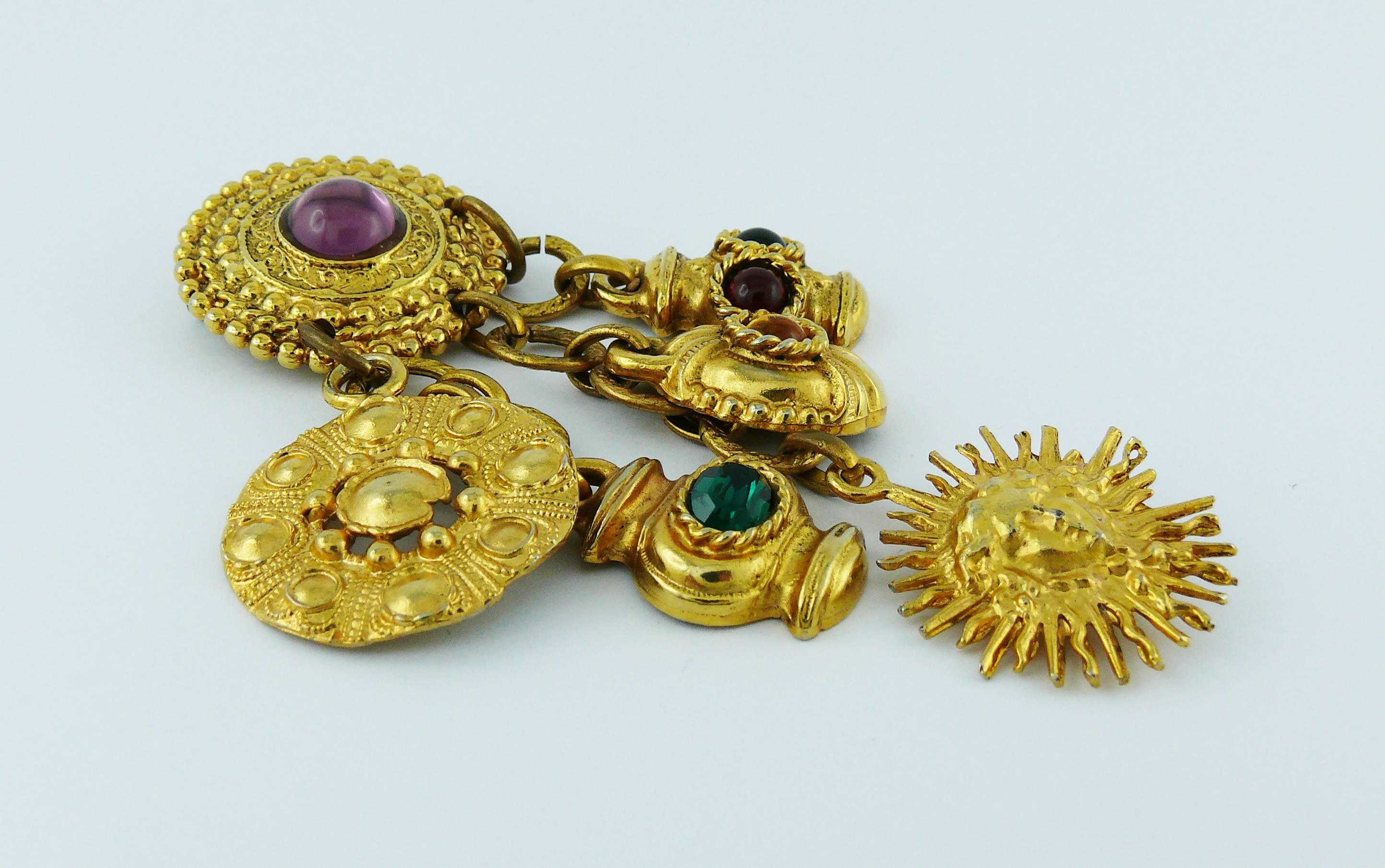 EDOUARD RAMBAUD vintage gold toned brooch featuring various charms embellished with multicolored glass cabochons and crystal.

Marked EDOUARD RAMBAUD Paris.

Indicative measurements : max. height approx. 10 cm (3.94 inches) / max. width approx. 4.3