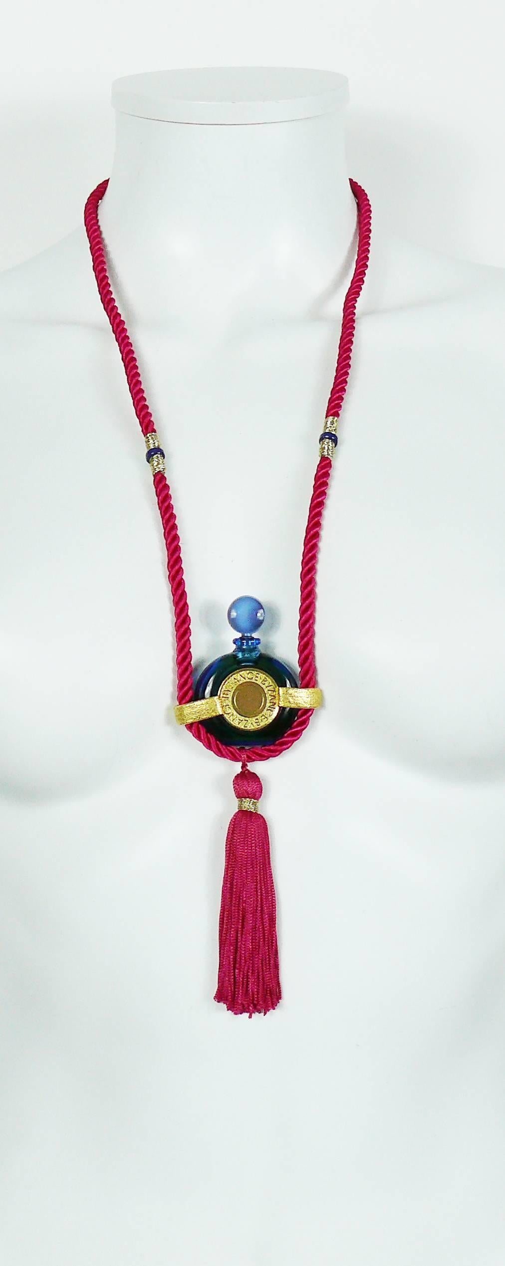 ROCHAS vintage BYZANCE tassel blue miniature bottle necklace featuring gold toned hardware and fuchsia pink cord strap with tassel hanging at the bottom.

Bottle still have perfume inside (looks full and unused).

Marked  BYZANCE on bottle