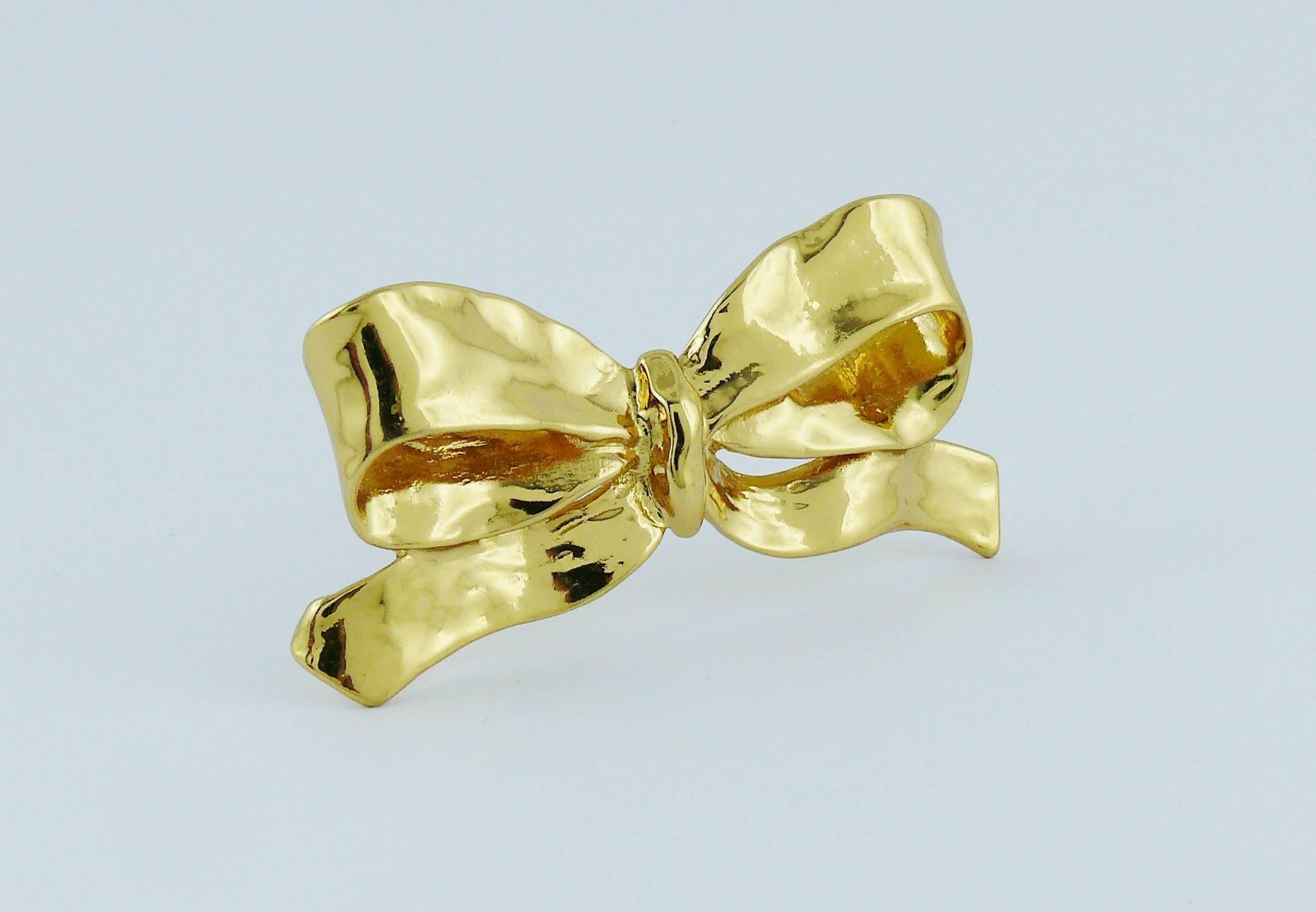YVES SAINT LAURENT vintage gold toned bow brooch featuring hammered finish.

Embossed YSL Made in France.

Indicative measurements : max. height approx. 3 cm (1.18 inches) / max. length approx. 7.5 cm (2.95 inches).

JEWELRY CONDITION CHART
- New or