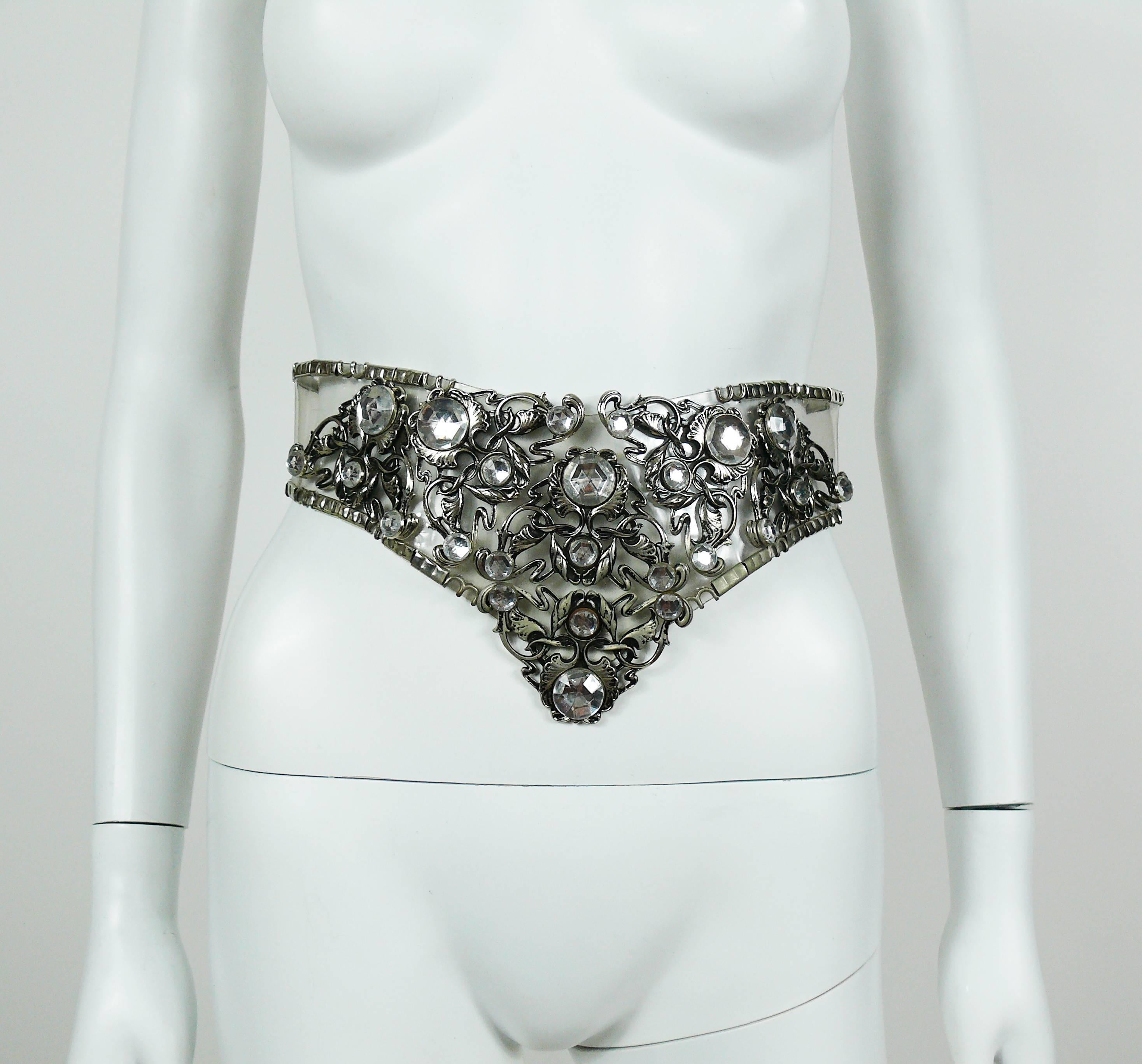 JOSE COTEL vintage rare clear vinyl belt featuring silver toned metal "Art Nouveau" inspired details embellished with resin crystals.

Hook closure.
Adjustable size.

Marked JOSE COTEL TM Made in France.
Dated 1985.

Indicative