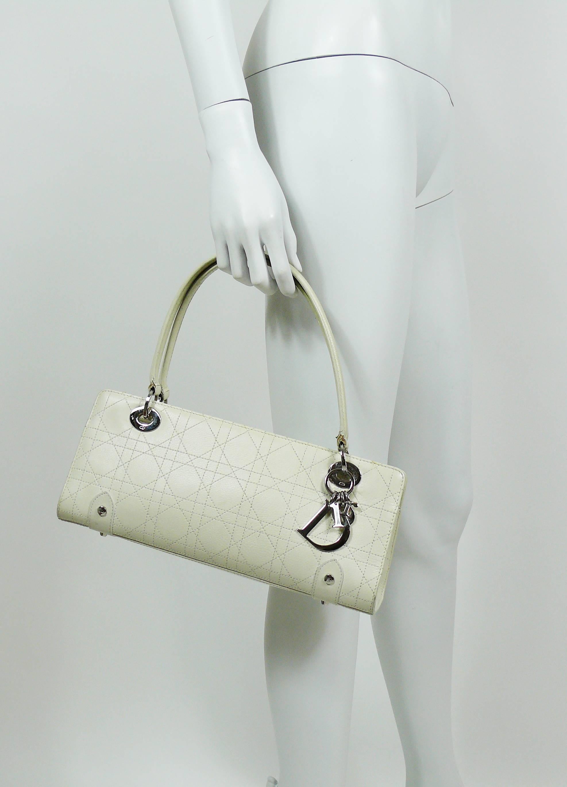 CHRISTIAN DIOR off white cannage East West Lady Dior handbag.

This bat features :
- Rectangular off-white leather body featuring the iconic signature geometric cannage quilting in white.
- Leather handles with silver toned links embossed with
