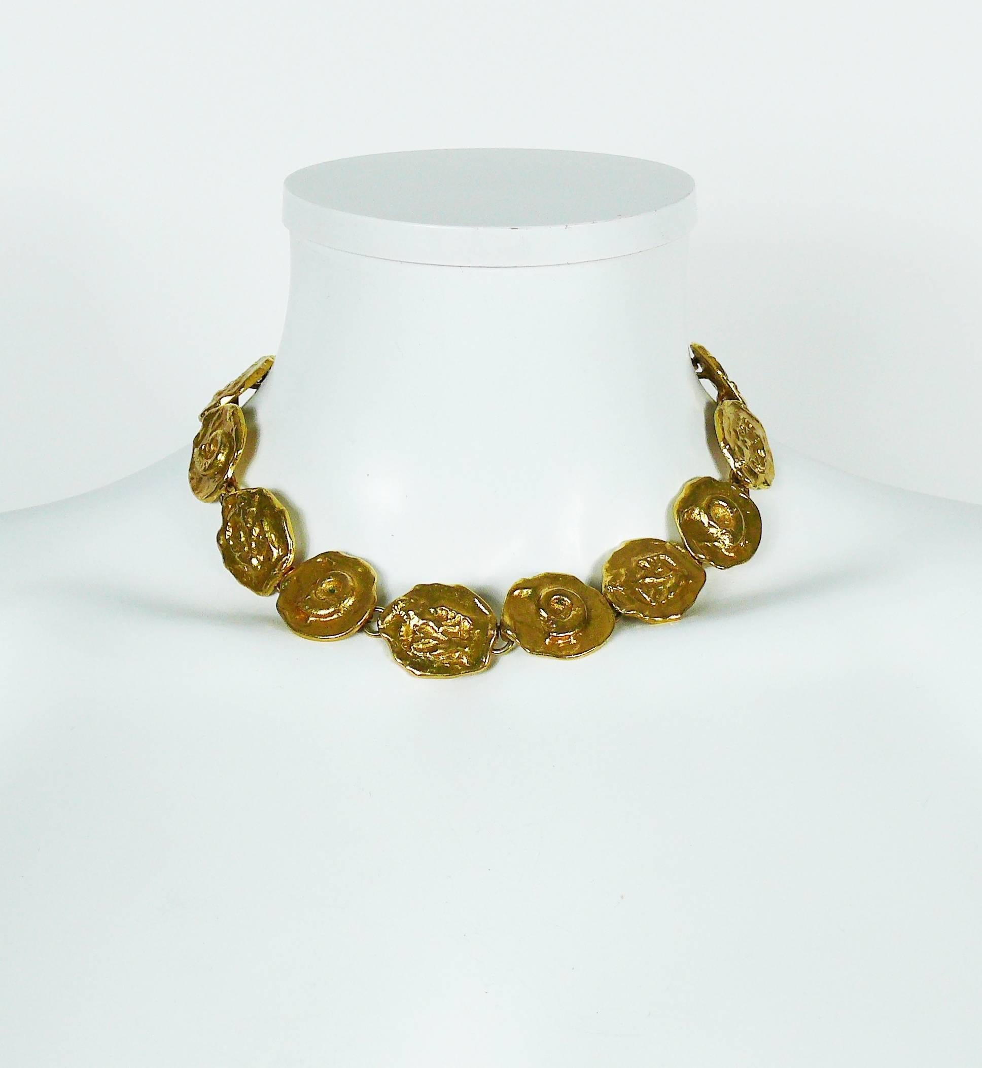 YVES SAINT LAURENT vintage rare and collectable gold toned necklace featuring fossil motif medallions.

Hook clasp closure.
Extension chain.

Indicative measurements : length from approx. 35.5 cm (13.98 inches) to approx. 39.5 cm (15.55 inches) /