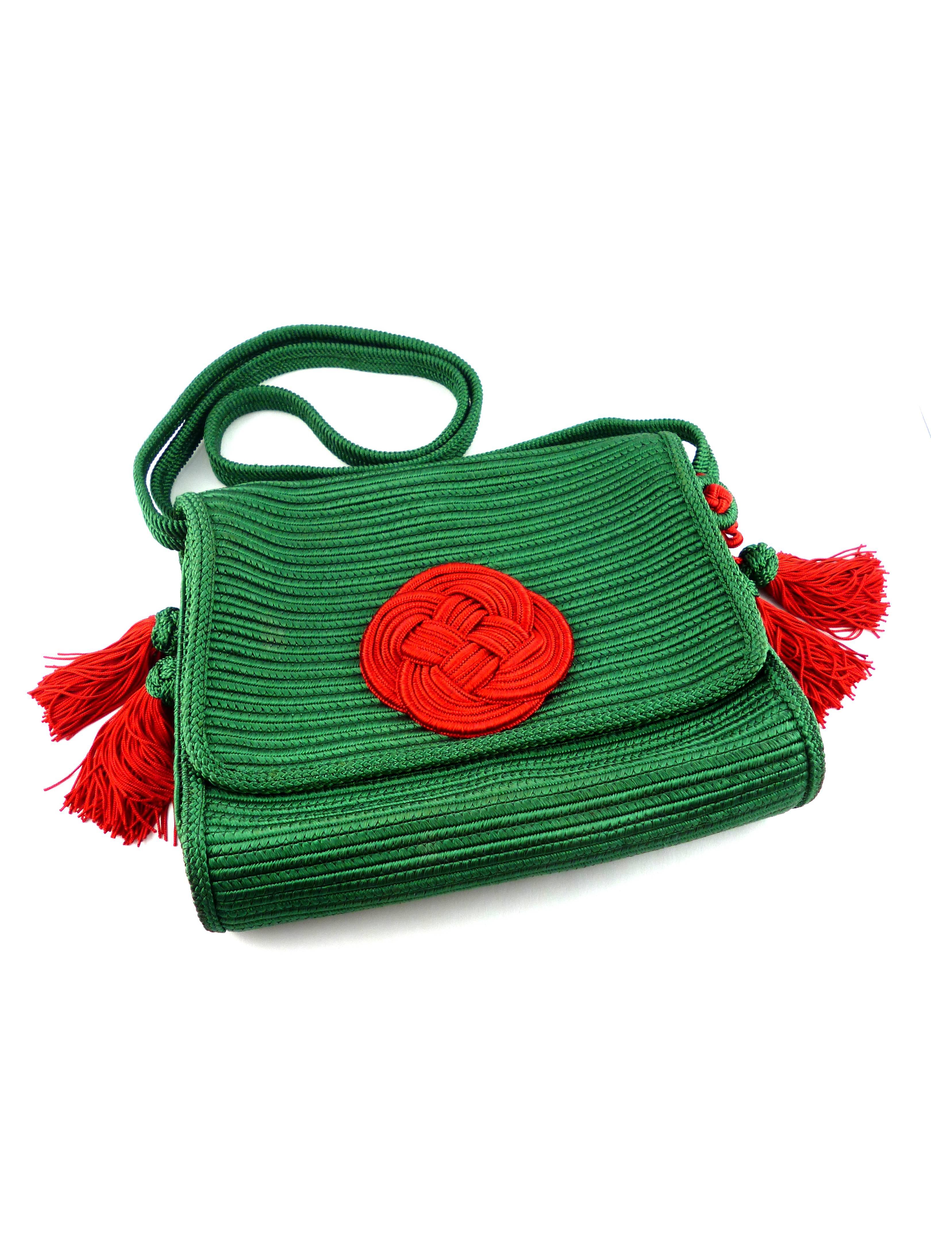 YVES SAINT LAURENT vintage rare 1977 Chinese Collection passementerie silk tassel purse bag.

Green silk body adorned with a massive red passementerie ornament.
Green and red silk tassels on both sides.

Embossed on a tag Yves Saint Laurent