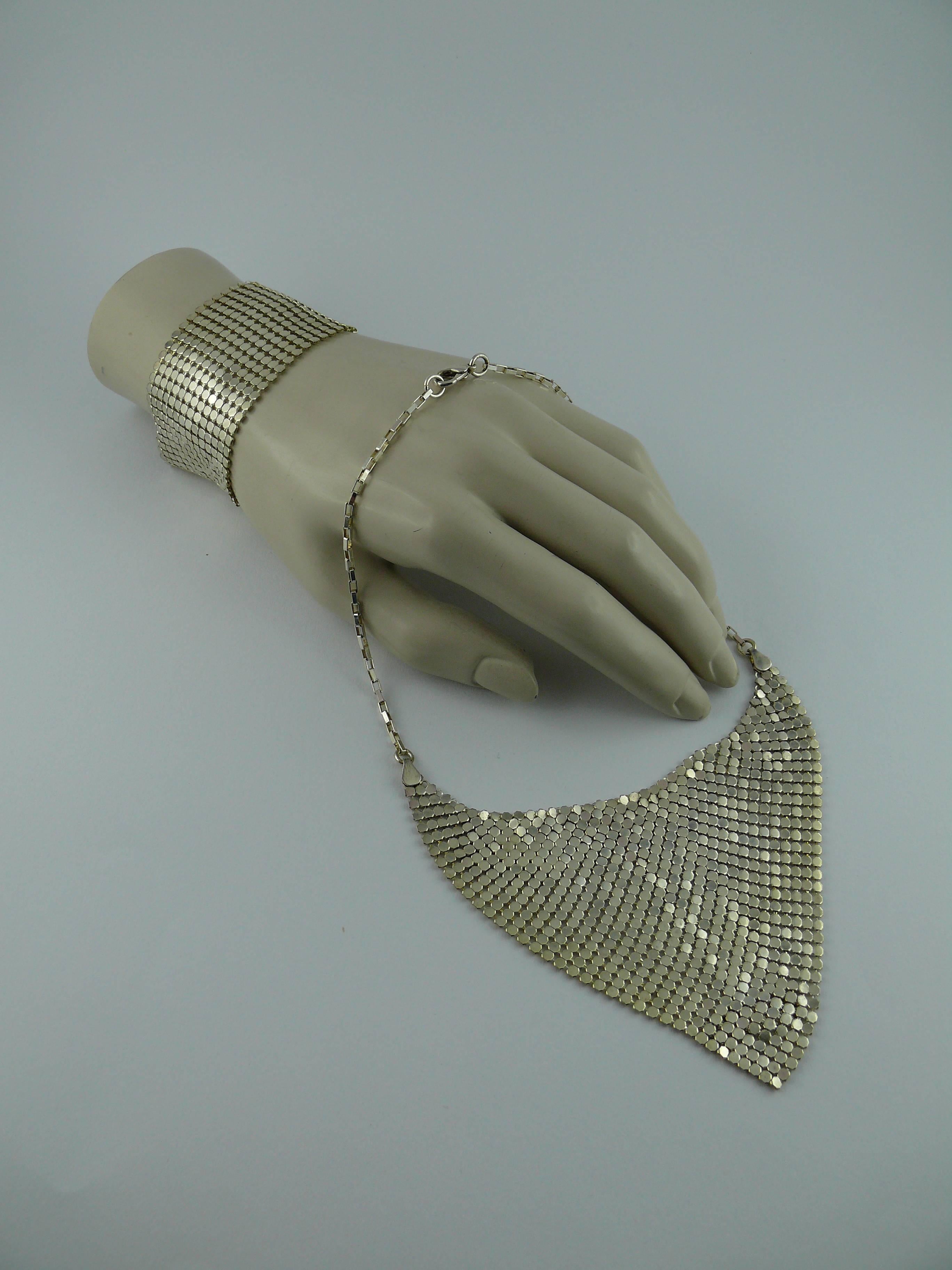 PACO RABANNE vintage disco silver tone mesh necklace and bracelet set.

Necklace is featuring a metal mesh triangle hanging on a silver tone rectangular link chain. It has a lobster closure.

Bracelet is made of 14 mesh strands and has a