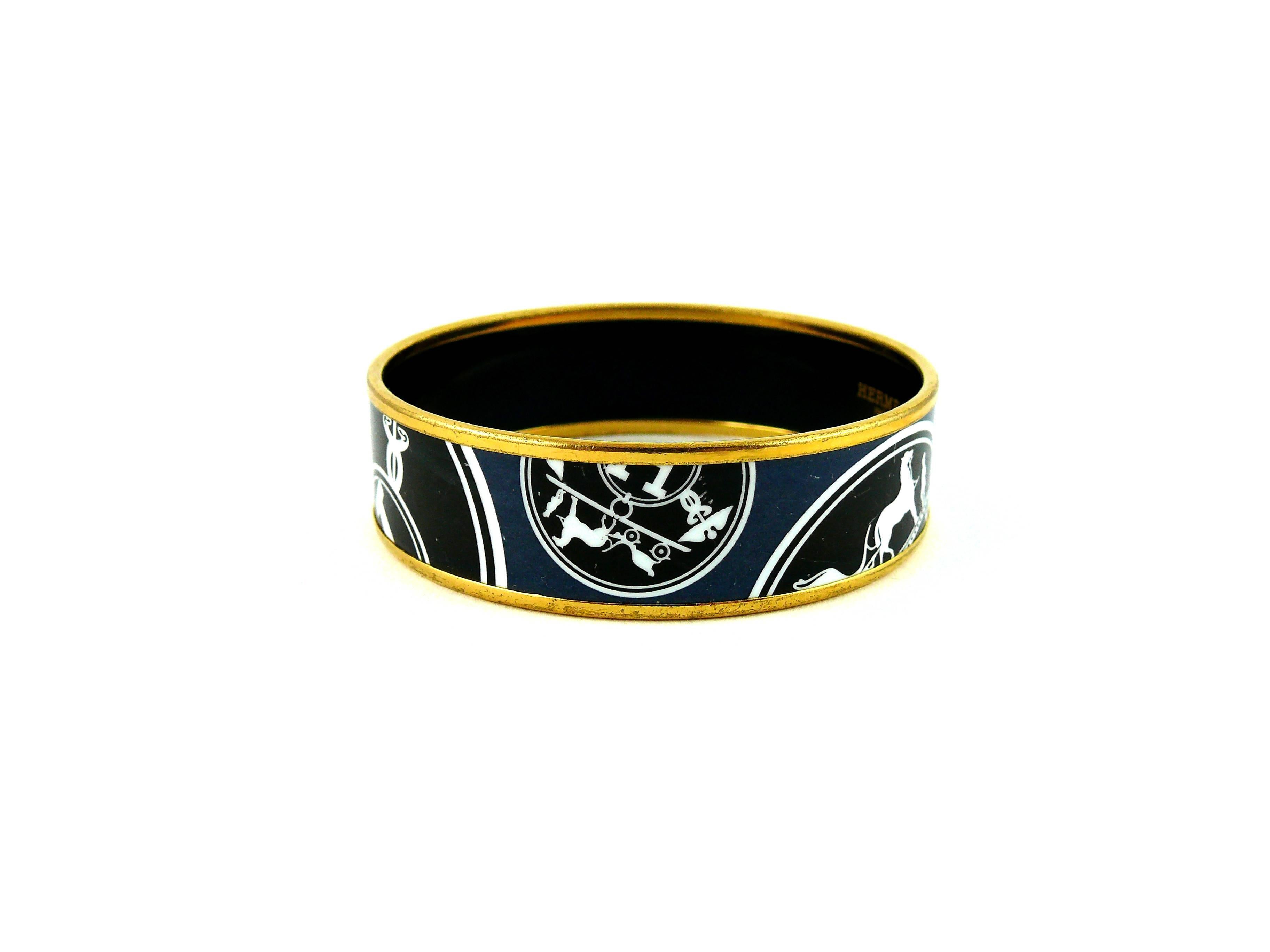 HERMES Paris gorgeous enamel printed wide bracelet.

Iconic white and black Hermes carriage logo on a blue background.

Gold plated rim.

Marked Hermes Paris Made in France + O.

