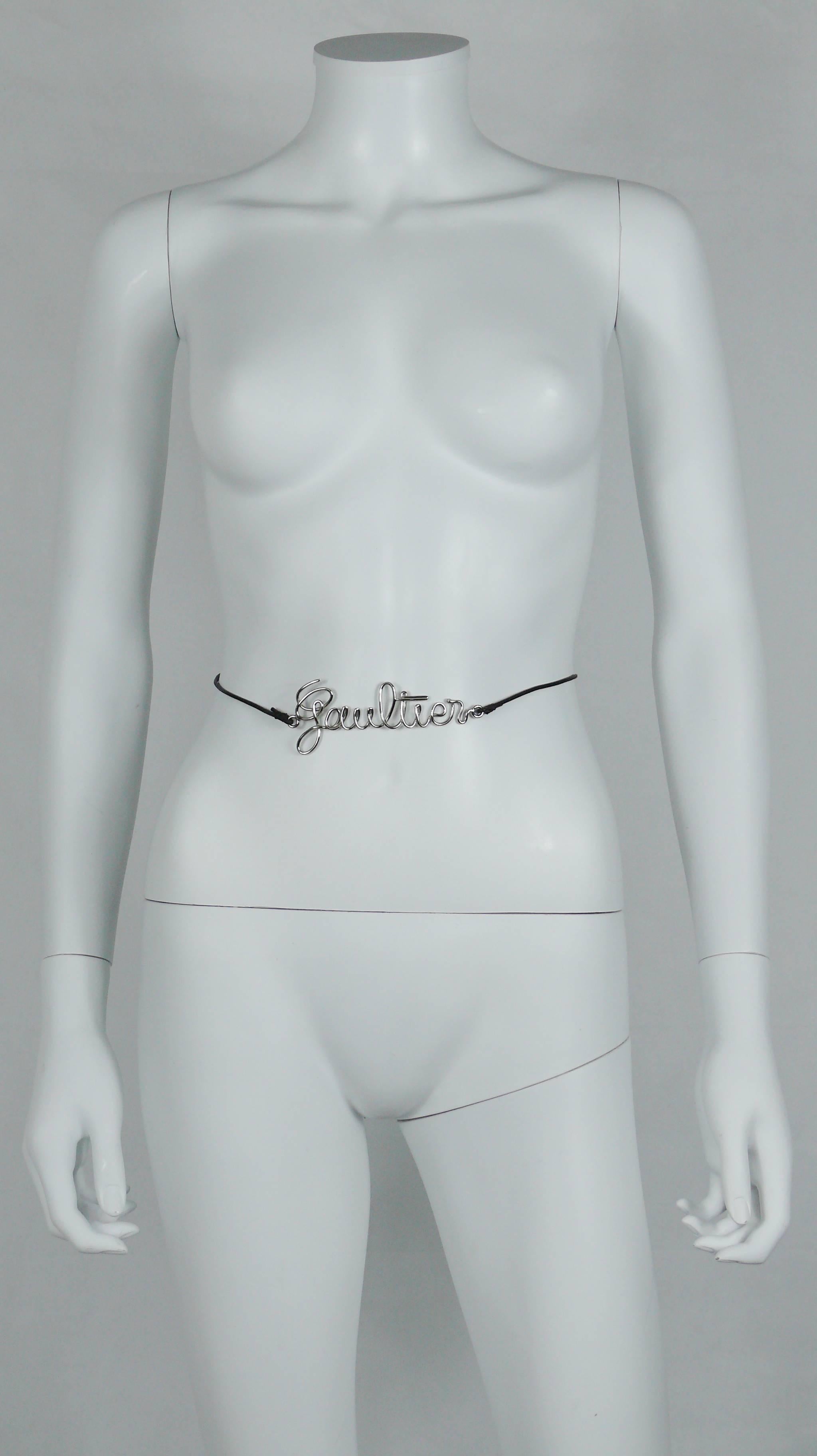 JEAN PAUL GAULTIER great cursive logo metal chrome thin belt with a black leather cord that ties in the back.

One size fits all.

Chrome logo measurements : 10.5 cm x 4.6 cm (4.13 inches x 1.81 inches).

BELT CONDITION CHART
- New or never