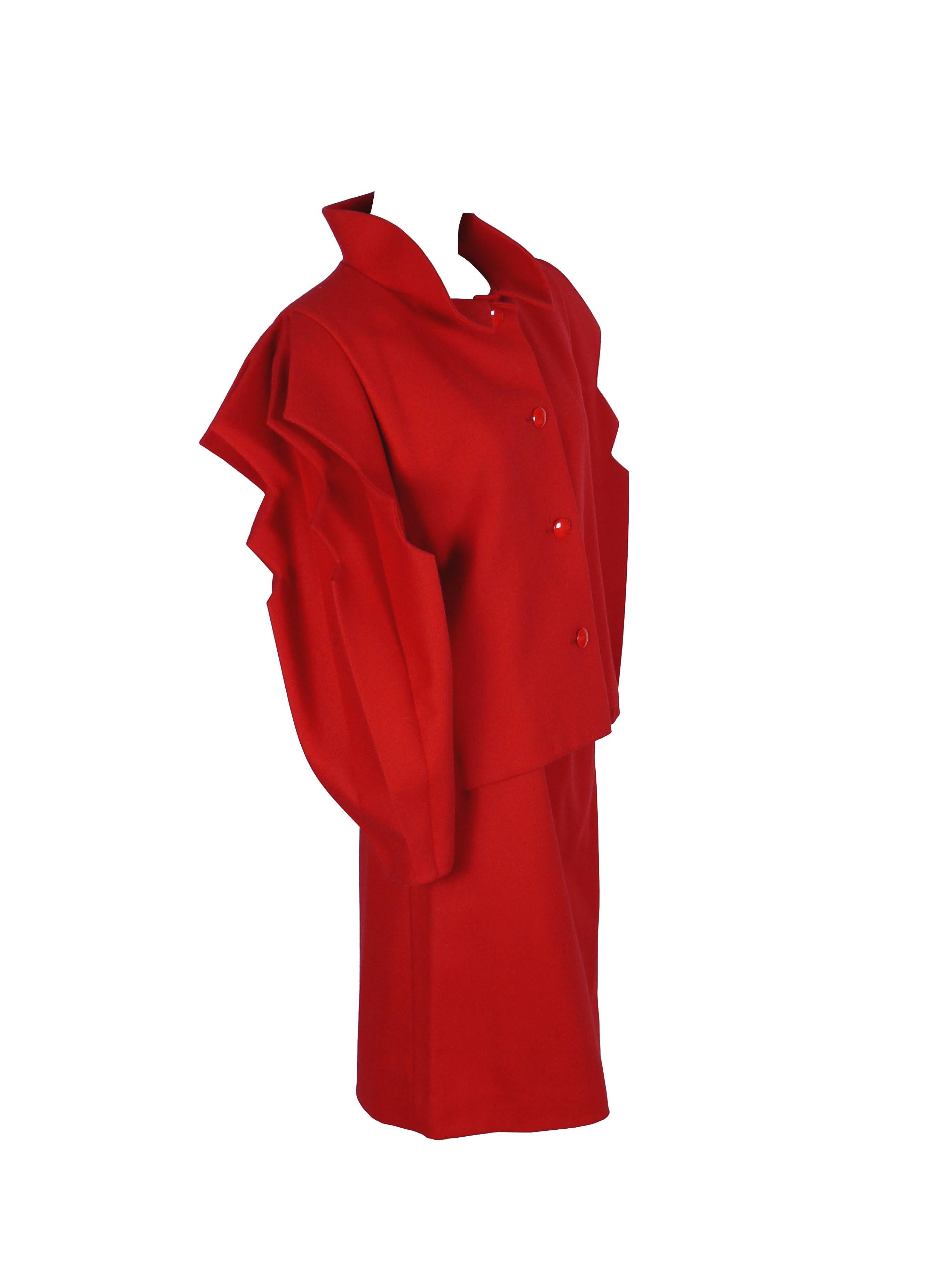PIERRE CARDIN Prestige intage red skirt suit.

Blazer has stunning cut-out accordion sleeves, rigid collar turned up and button fastening.

Straight skirt with zip closure.

Both jacket and skirt are fully lined.

Label reads PIERRE CARDIN