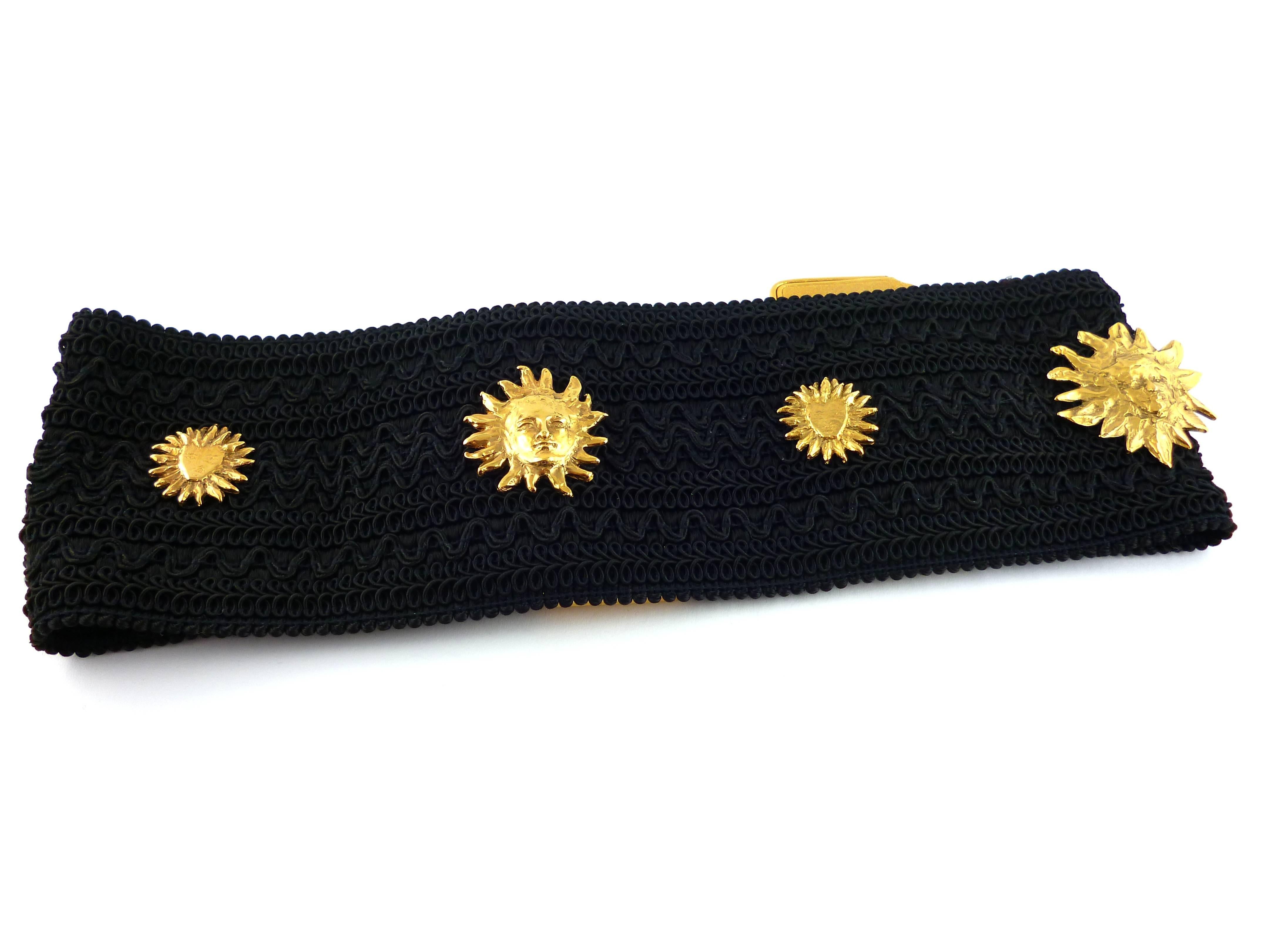 YVES SAINT LAURENT vintage wide waist belt with sun face theme.

Textured stretch black fabric with gold plated hardware.

S-shaped closure.

One size fits all.

Marked YSL Made in France.

Indicative weight : 480 grams.

BELT CONDITION CHART
- New