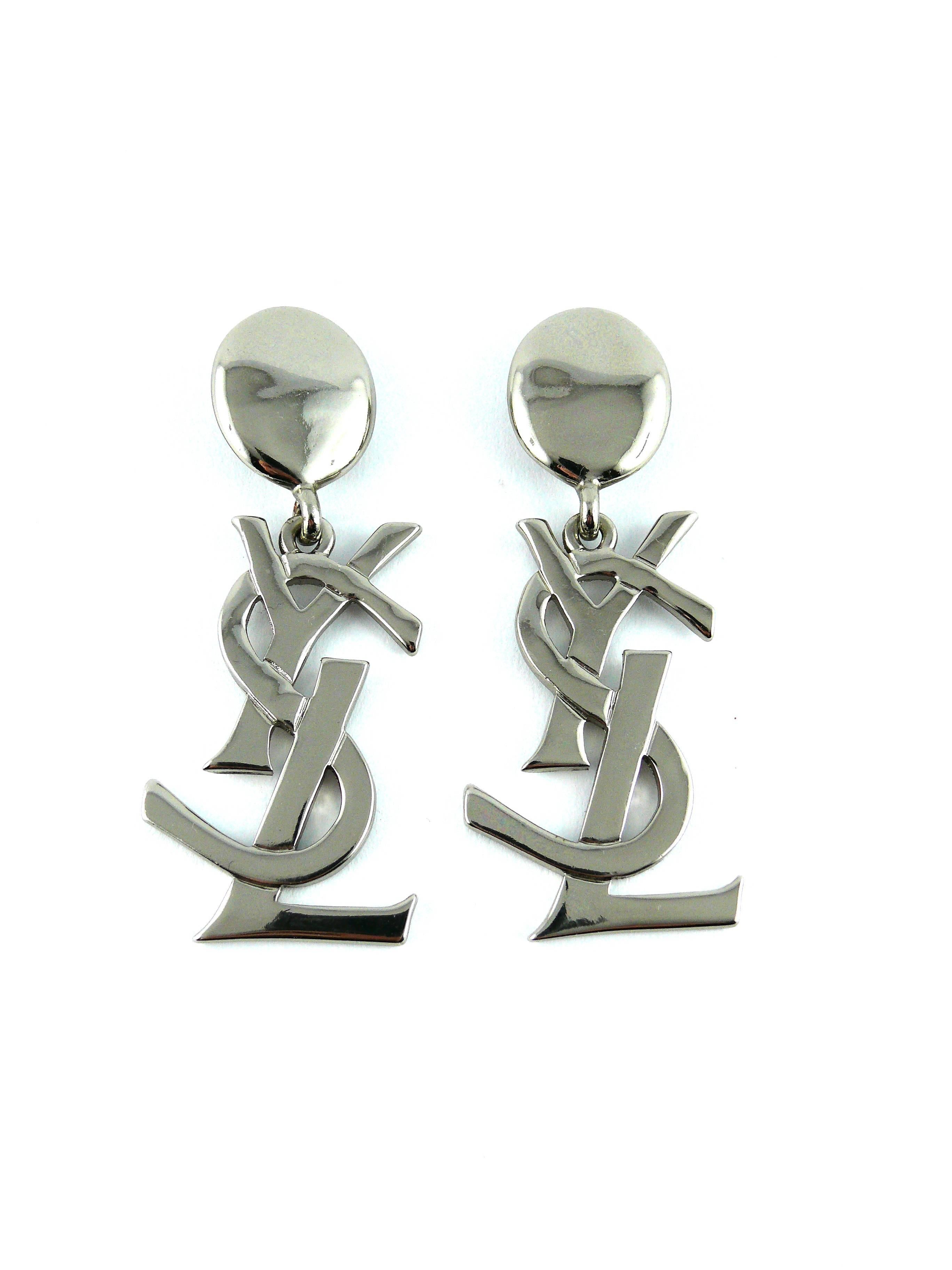 YVES SAINT LAURENT massive vintage silver tone iconic logo dangling earrings (clip on).

Rare and collectable item !
As seen on Samantha Jones (Kim Cattrall) in SATC 2.

Marked YSL Made in France.

Comes with original box (used).

Note
As