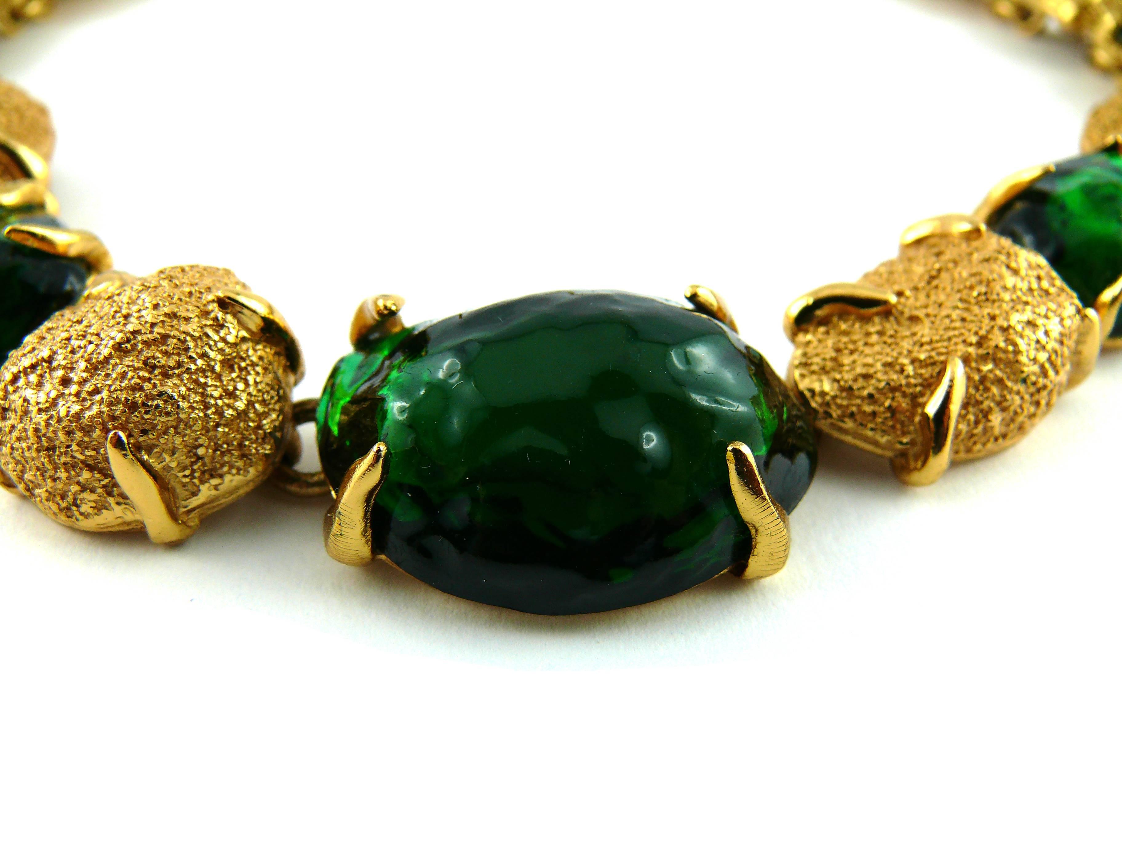 YVES SAINT LAURENT vintage necklace featuring gold tone nuggets and faux emerald cabochons.

Created by parurier ROBERT GOOSSENS.

Yves Saint Laurent love clasp with T-bar closure.

Embossed YVES SAINT LAURENT Paris Made in France.

Comes