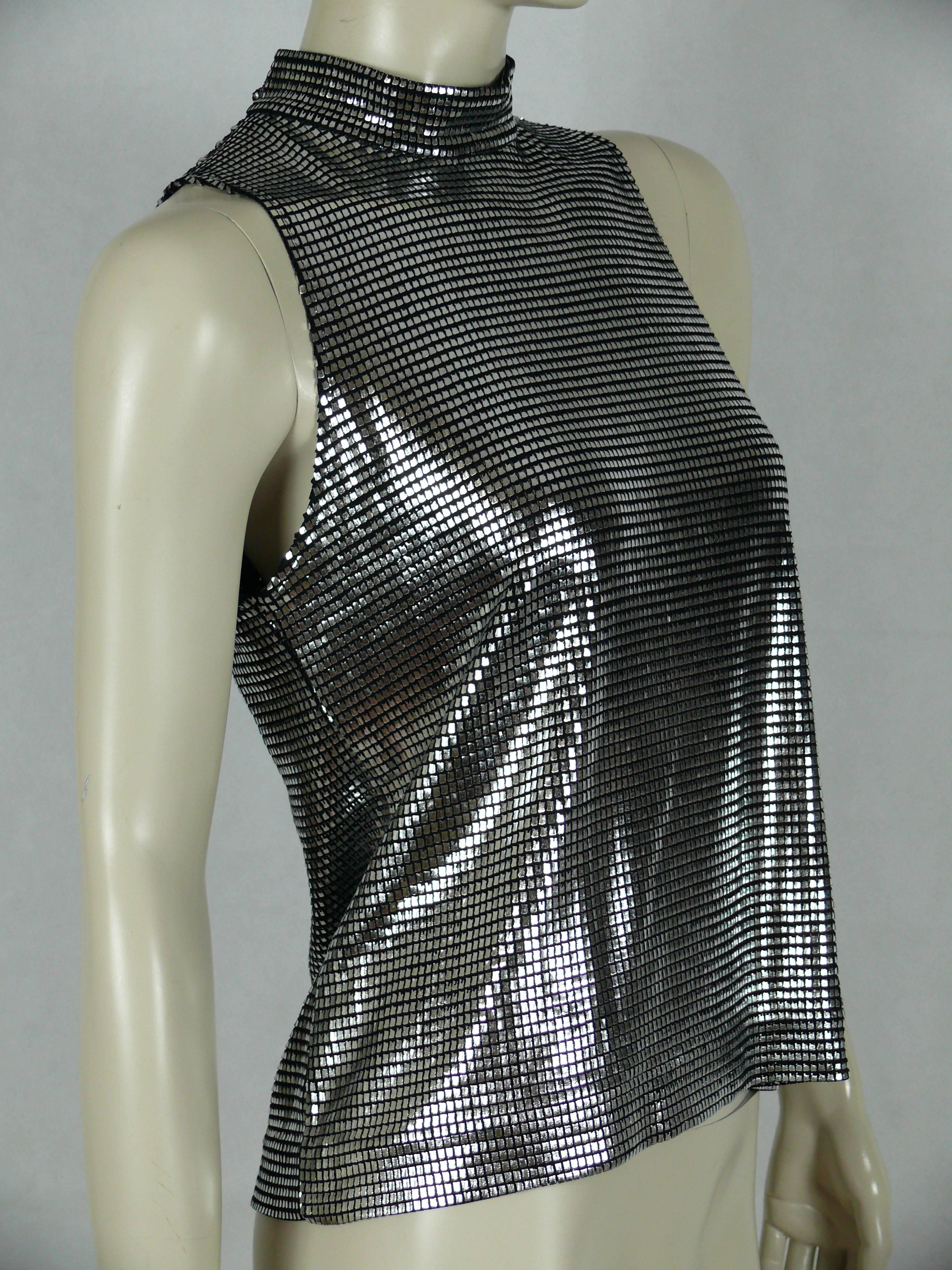 PACO RABANNE silver foil grid sleeveless top.

Top surface is silver foil printed creating a metallic chain mail effect on a black knit spandex base.

Buttoning at the back.

Label reads PACO RABANNE Paris.
Made in France.

Size tag reads :