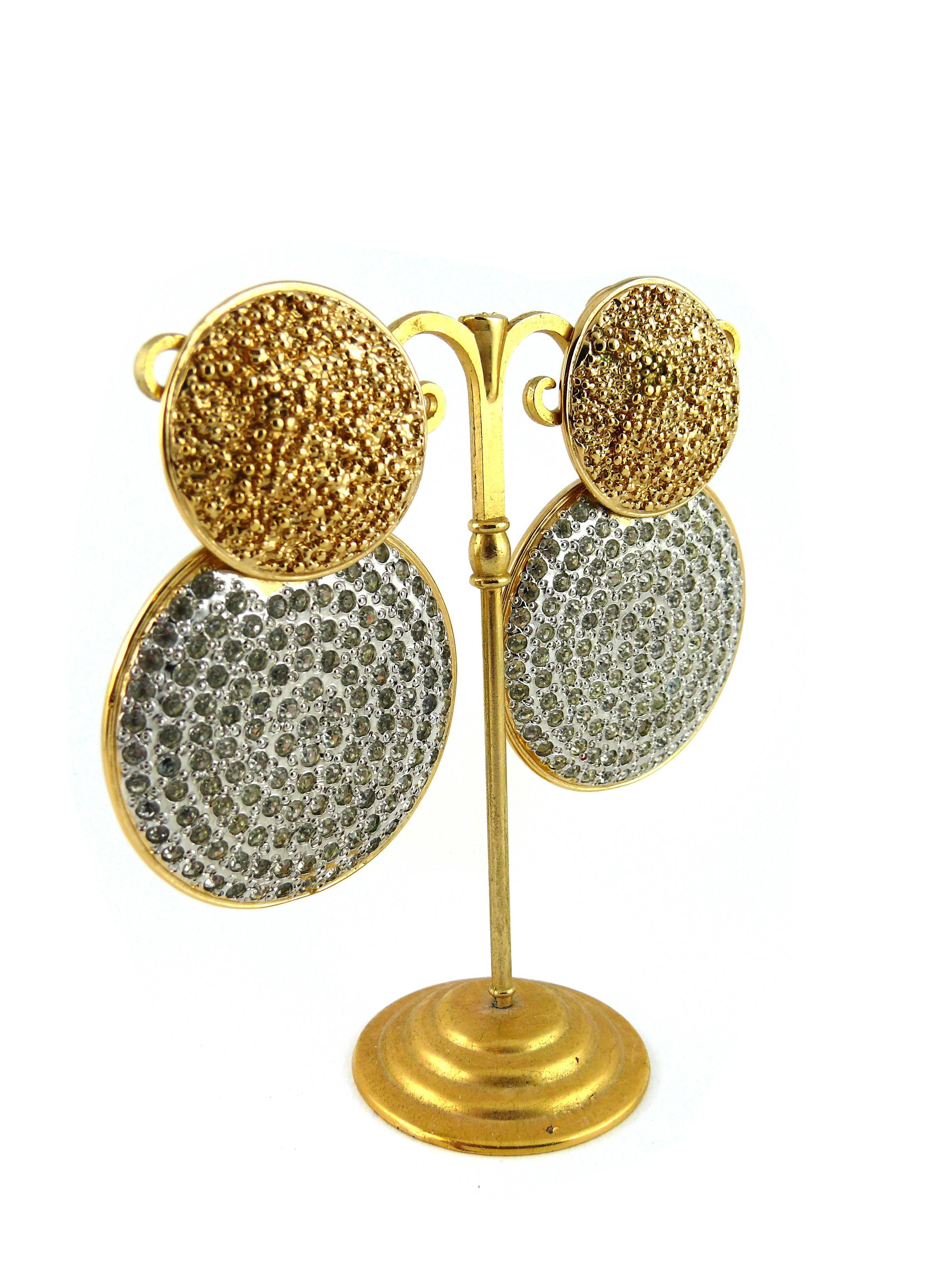 YVES SAINT LAURENT vintage massive jewelled dangling disc earrings.

These rare statement earrings feature two gold tone discs with crystal embellishement.

Embossed YSL.

JEWELRY CONDITION CHART
- New or never worn : item is in pristine