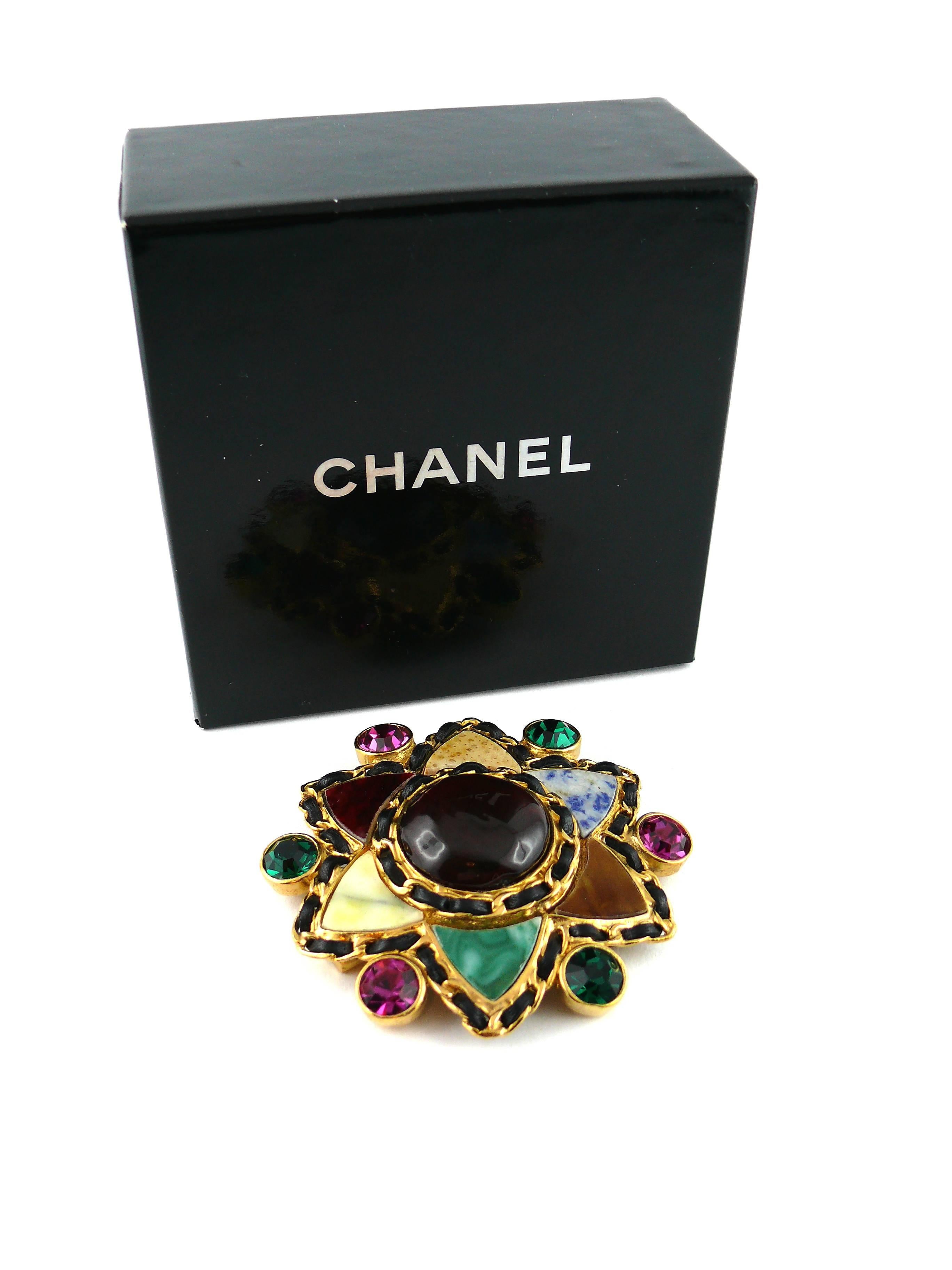 CHANEL massive vintage star brooch featuring a large Maison Gripoix red glass cabochon adorned with hardstone stone elements, multi colored crystals and intertwined leather detail.

This stunning brooch featured on the 1995 CHANEL Collection cover