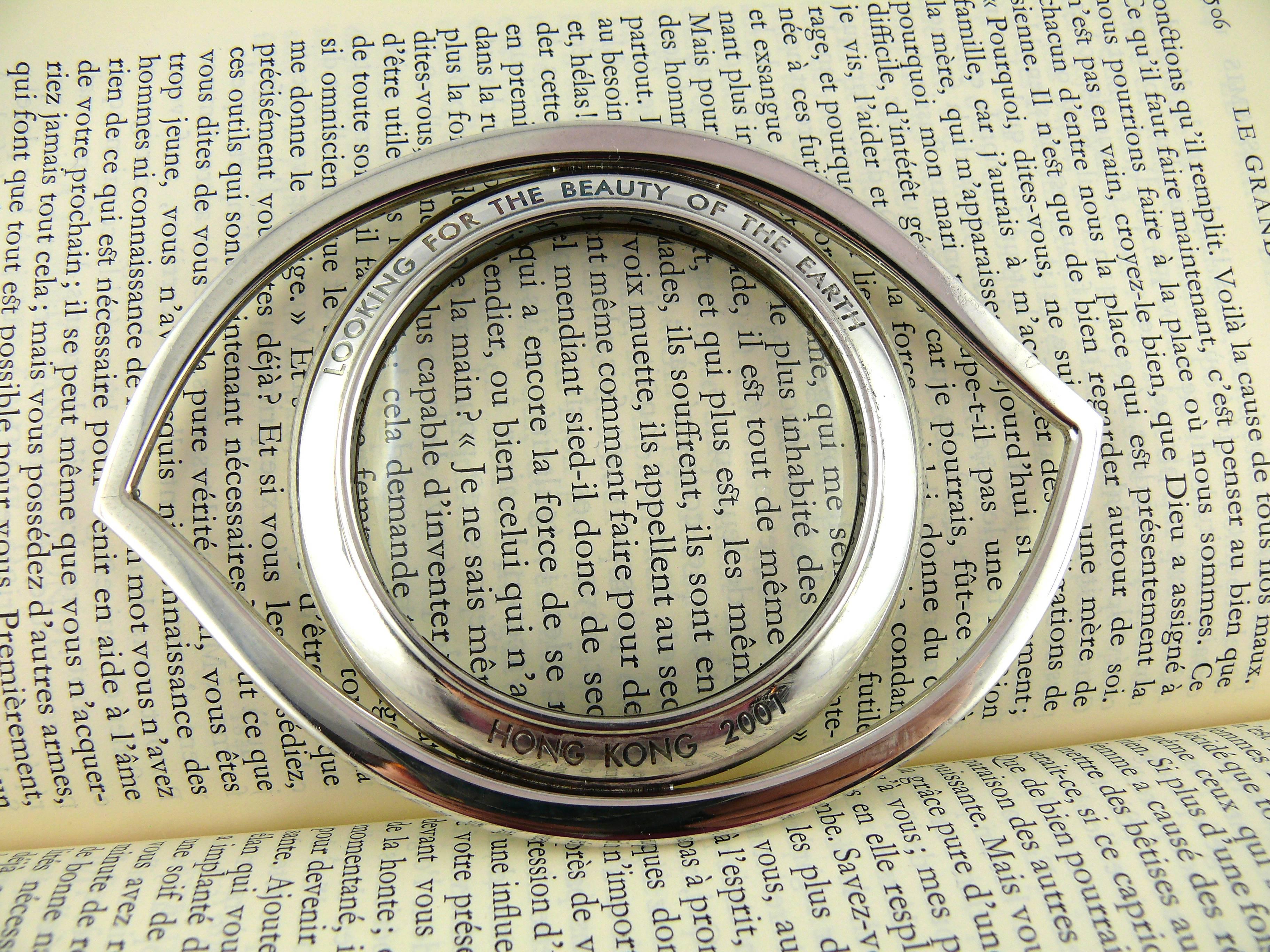 HERMES silver plated desk magnifying glass featuring a massive eye.

Engraved quote 