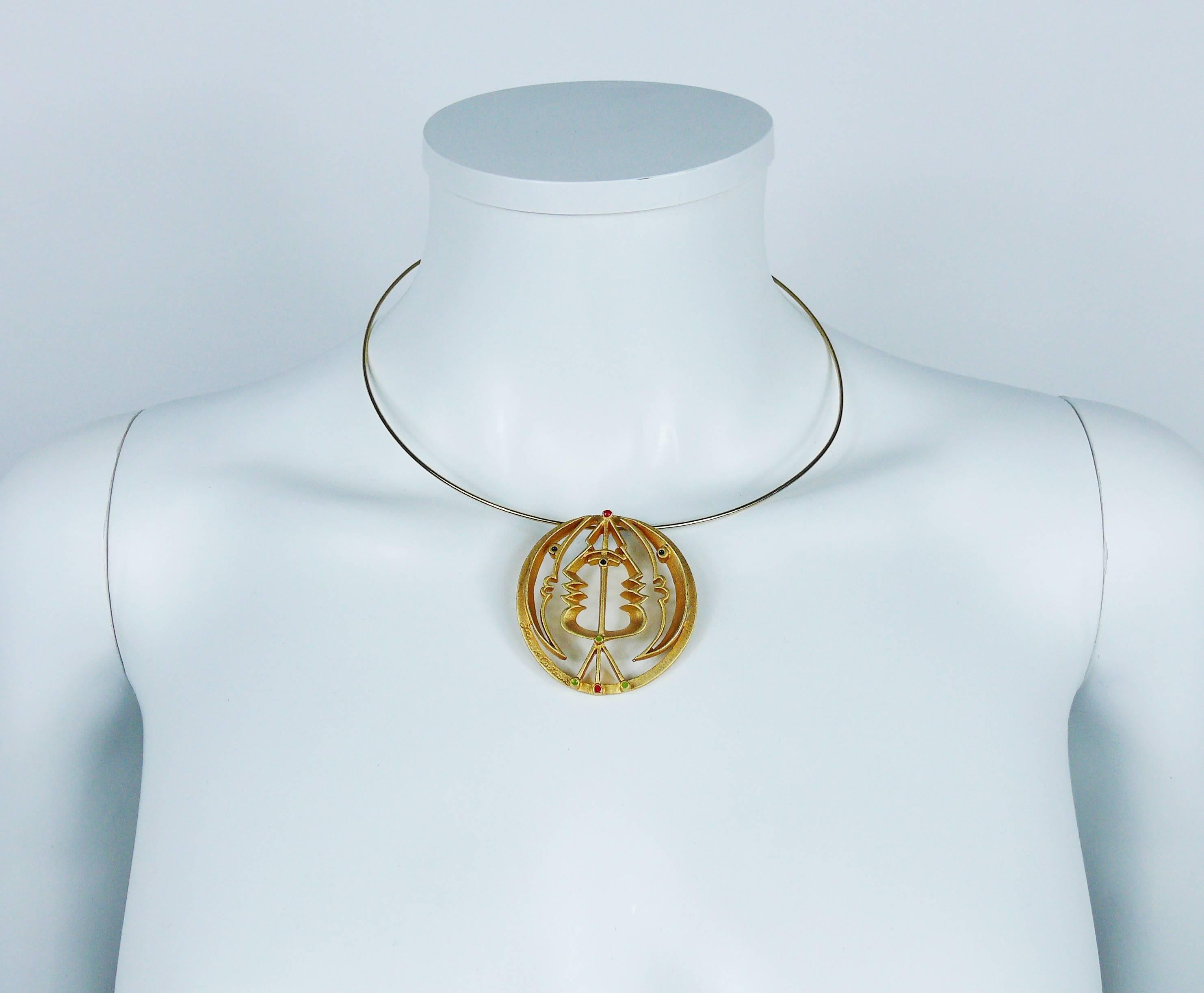 JEAN COCTEAU moon and profile sculpture pendant necklace edited by MADELINE FLAMMARION.

Matte gold toned sculpture pendant with multi colored enamel details featuring abstract profiles and crescent moon.

Semi rigid collar.

Signed JEAN