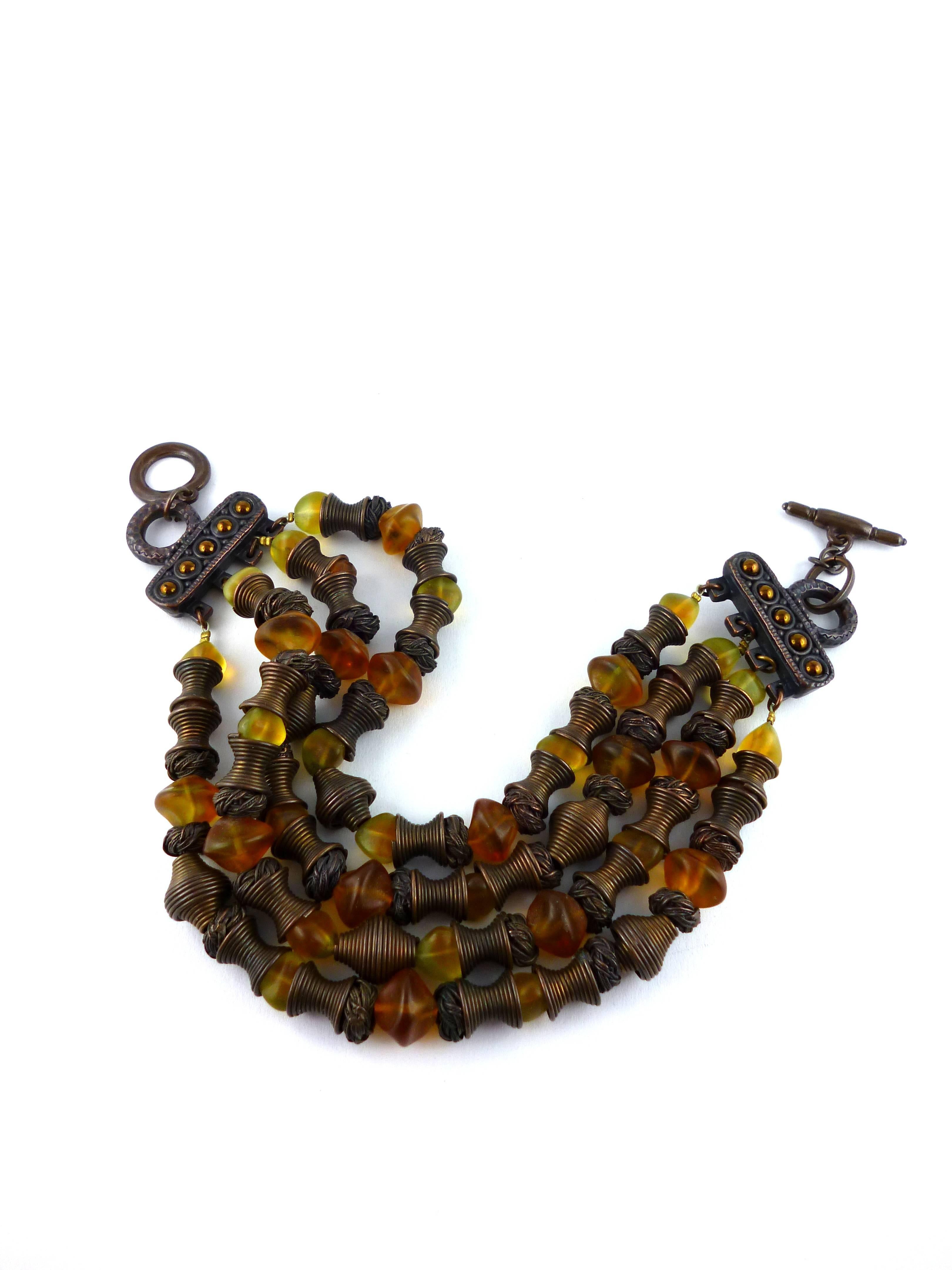JEAN PAUL GAULTIER vintage Massaï choker necklace consisting of four raws of metal and irregular amber glass beads.

Embossed JPG.

Note
As a buyer, you are fully responsible for customs duties, other local taxes and any administrative