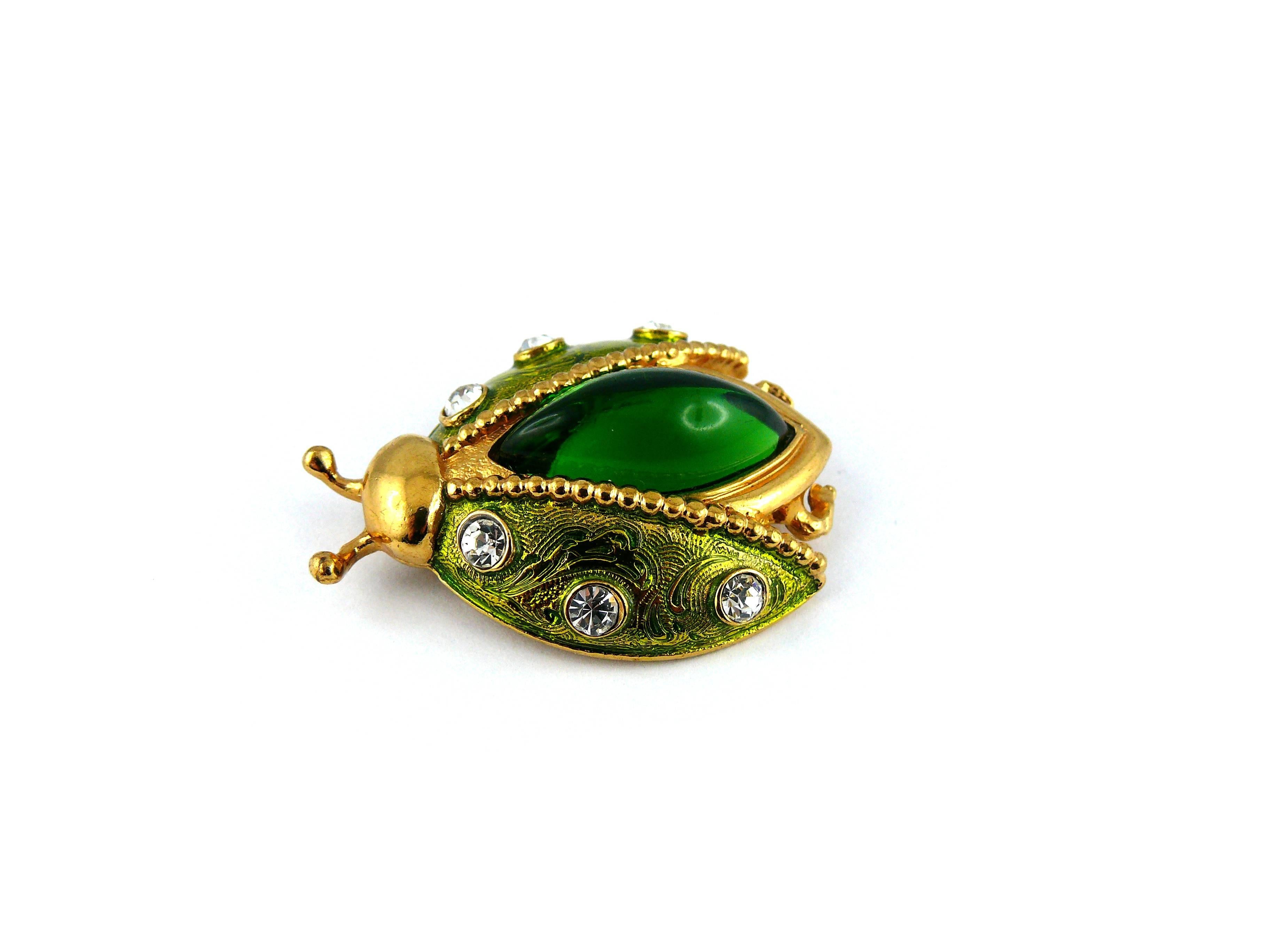 CHRISTIAN DIOR vintage rare jeweled ladybug brooch.

Enameled gold tone metal, embellished with white rhinestones and a green resin domed almond cabochon.

Marked PARFUMS CHRISTIAN DIOR.

JEWELRY CONDITION CHART
- New or never worn : item is in
