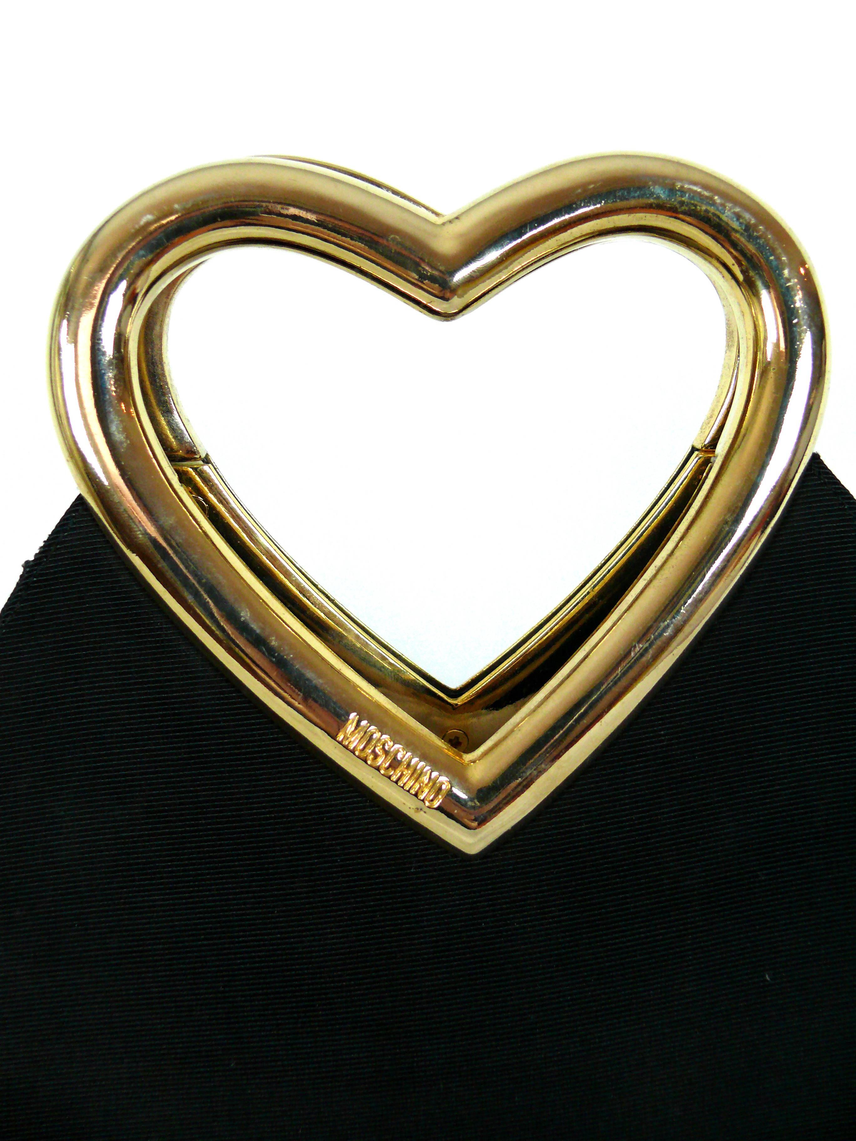 MOSCHINO vintage black ribbed nylon bag featuring a stunning gold tone rigid heart shaped handle.

One inside zip pocket.

Snap closure.

Embossed MOSCHINO on both sides of the handle.

Zip pull embossed Centropercento MOSCHINO REDWALL Made