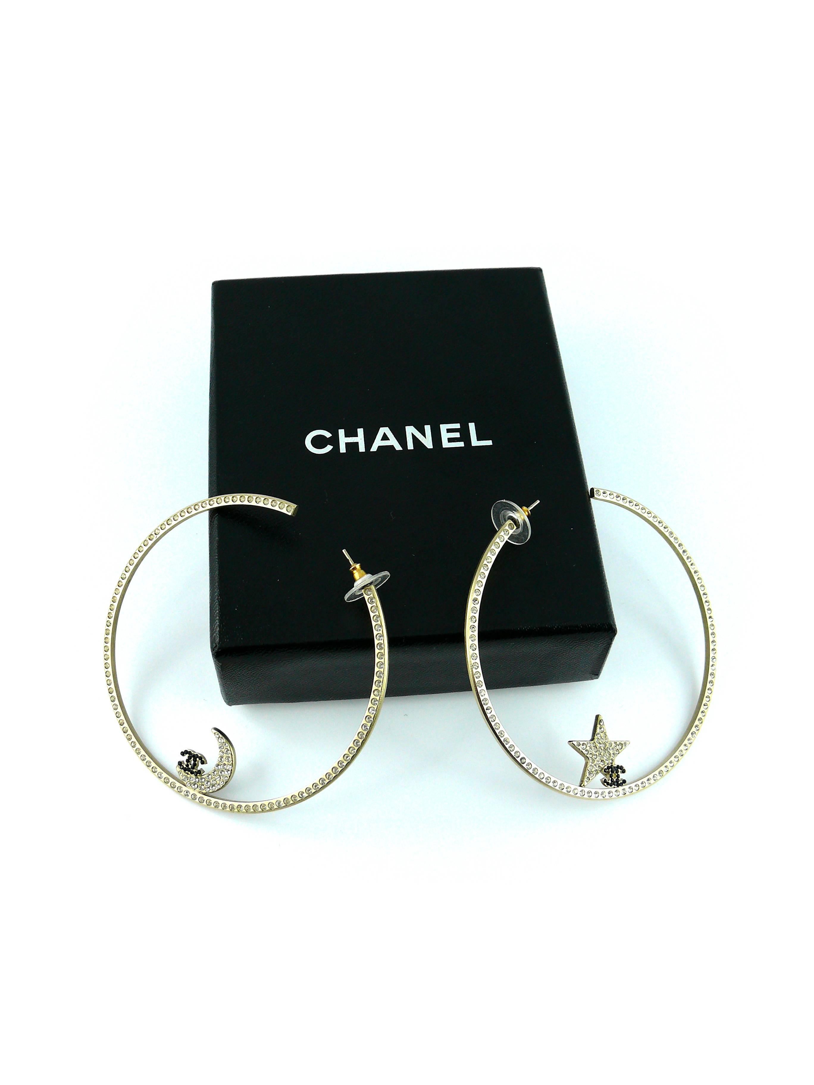 CHANEL massive gold tone hoop earrings with white and jet crystal embellishement featuring a crescent moon and a star with CC logo.

Spring/Summer 2006 Collection.

Stamped CHANEL 06 P Made in Italy.

Comes with original box and dust bag.

JEWELRY