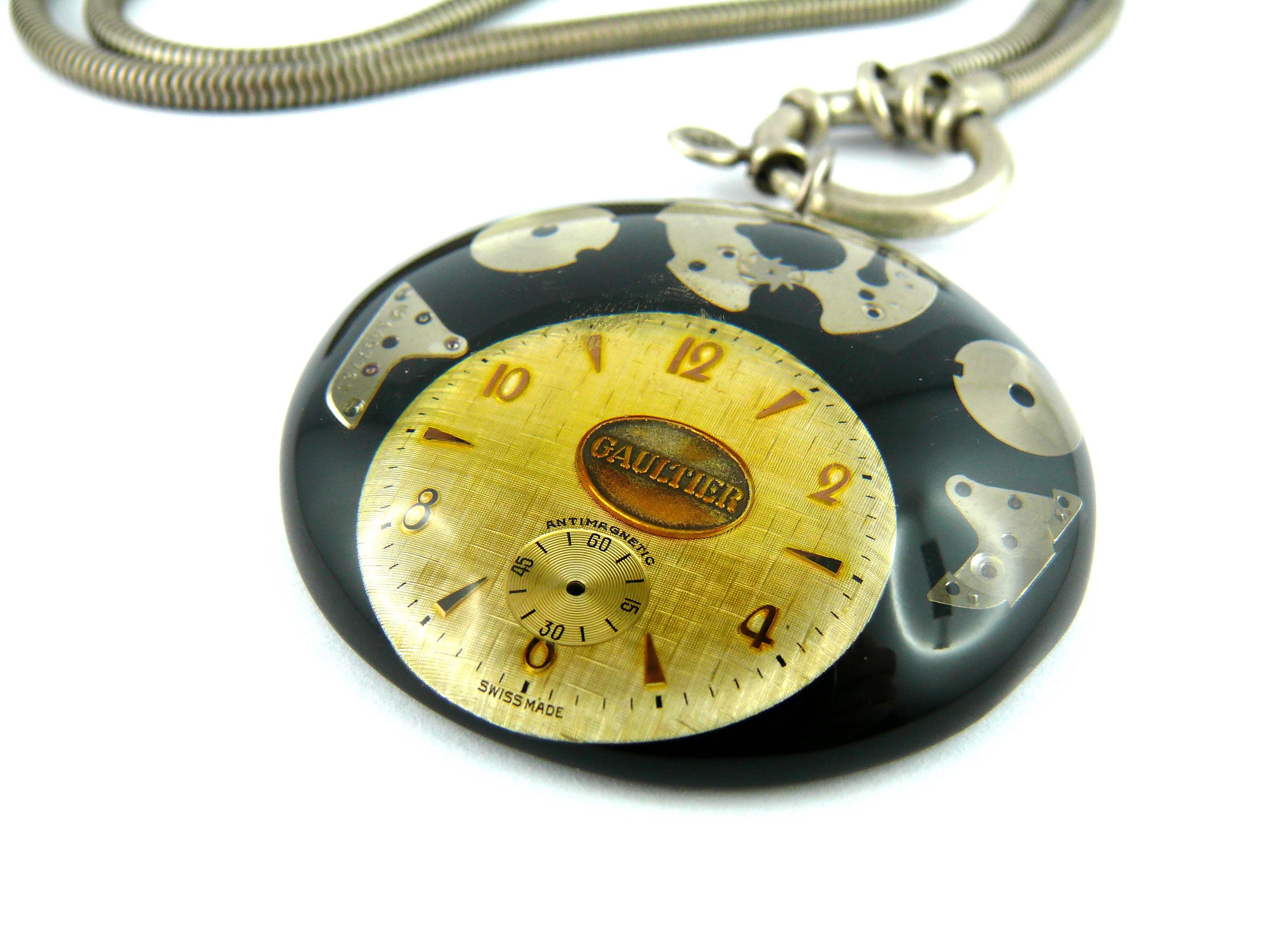 JEAN PAUL GAULTIER vintage rare and collectable steampunk clock necklace.

Chunky steel metal snake chain featuring a massive domed resin pendant with a clock inlaid. 

Marked GAULTIER.

Indicative measurements : total length worn approx. 42.5 cm