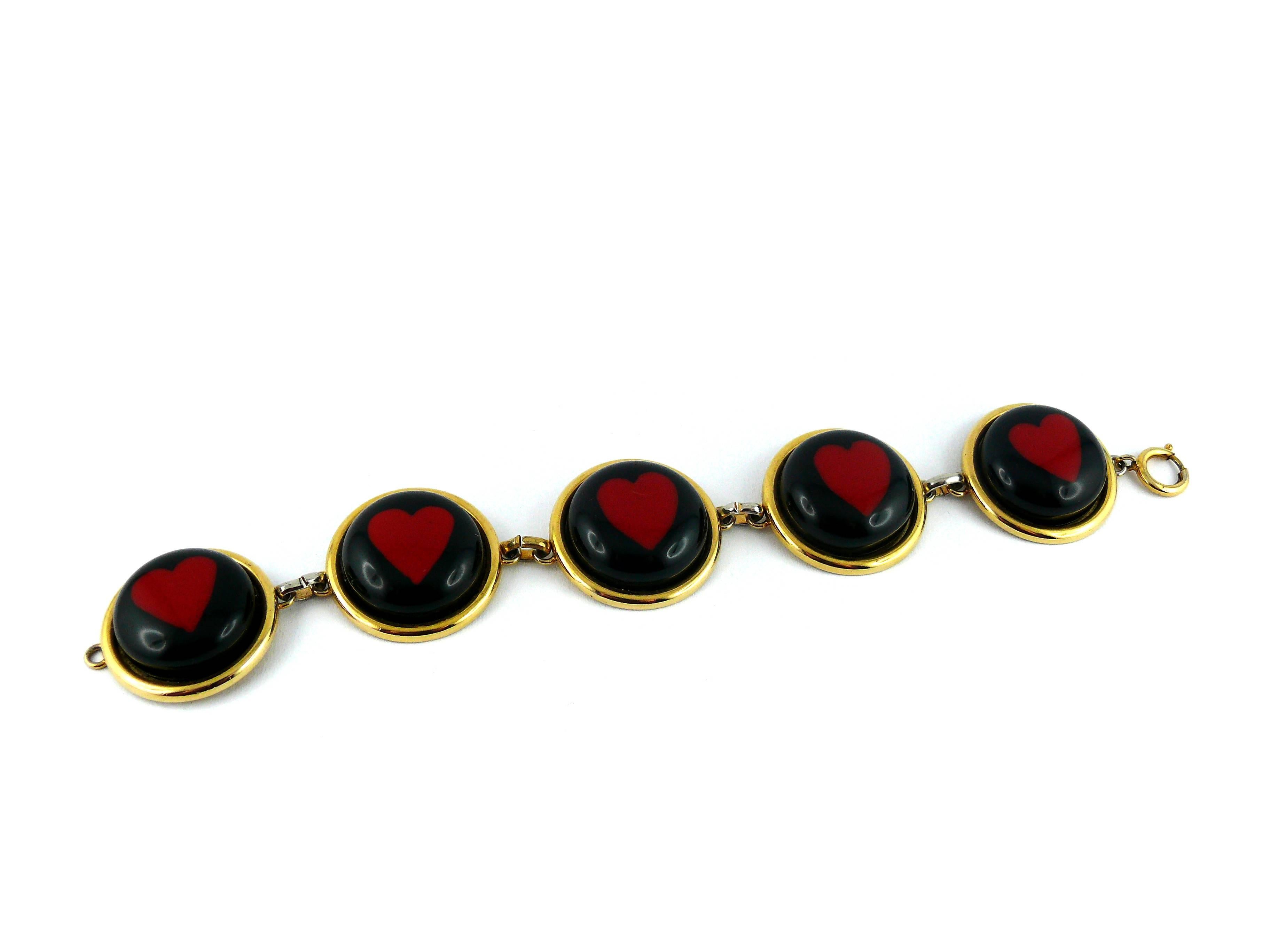 MOSCHINO vintage rare bracelet by UGO CORREANI featuring 5 black and red lucite heart medallions.

Embossed MOSCHINO.

JEWELRY CONDITION CHART
- New or never worn : item is in pristine condition with no noticeable imperfections
- Excellent : item
