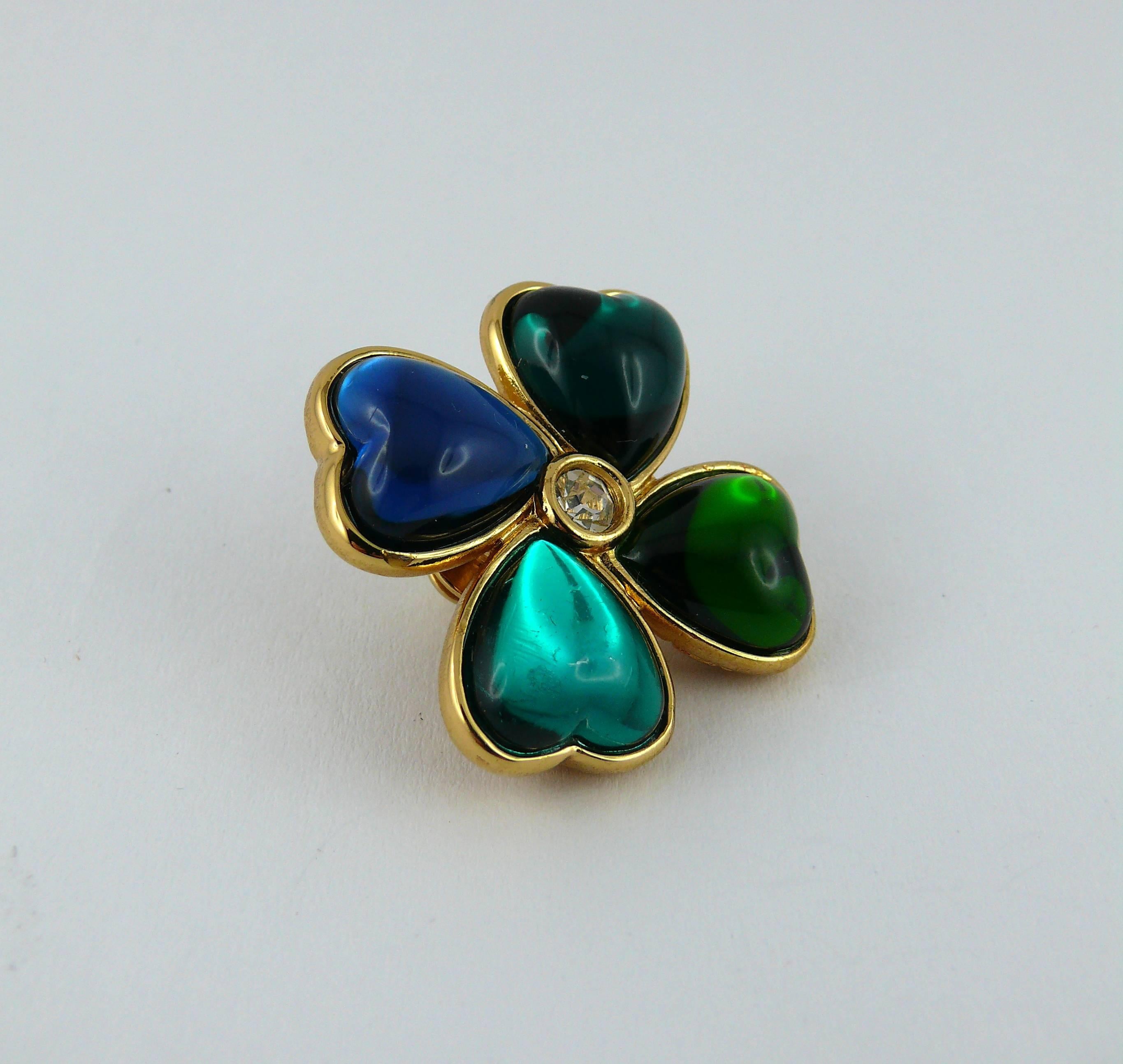 YVES SAINT LAURENT vintage clover brooch featuring heart petals.

This brooch consists of blue and green shades resin petals in a gold tone setting. White rhinestone embellishement.

Pin closure.

Marked YSL Made in France.

JEWELRY