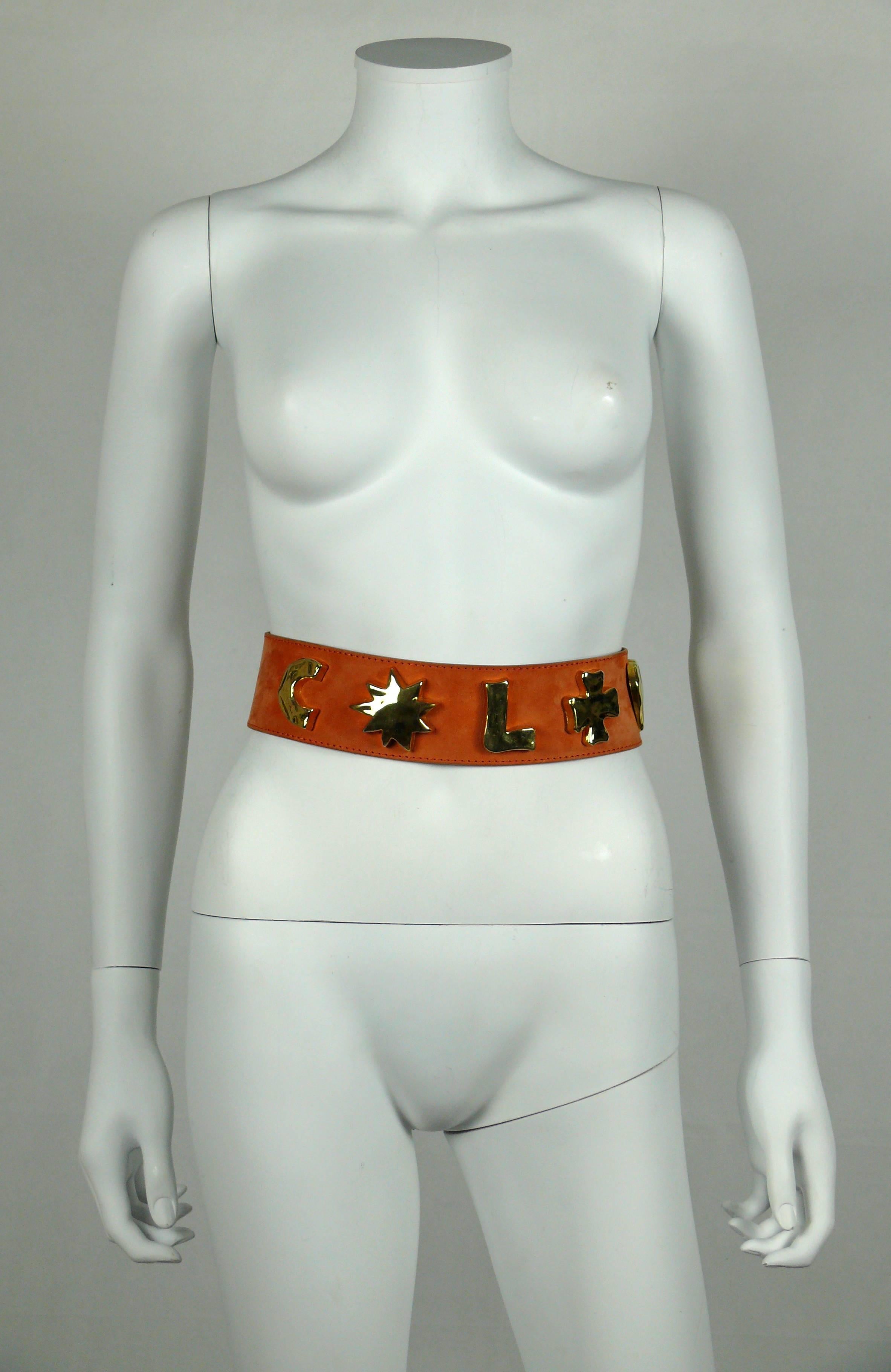 CHRISTIAN LACROIX vintage wide peach suede leather belt featuring iconic gold toned symbols (sun, cross, heart) and C.L. initials.

Hook fastening.

Marked CHRISTIAN LACROIX Paris.

Indicated size 65/26.

Made in France.

Indicative measurements :