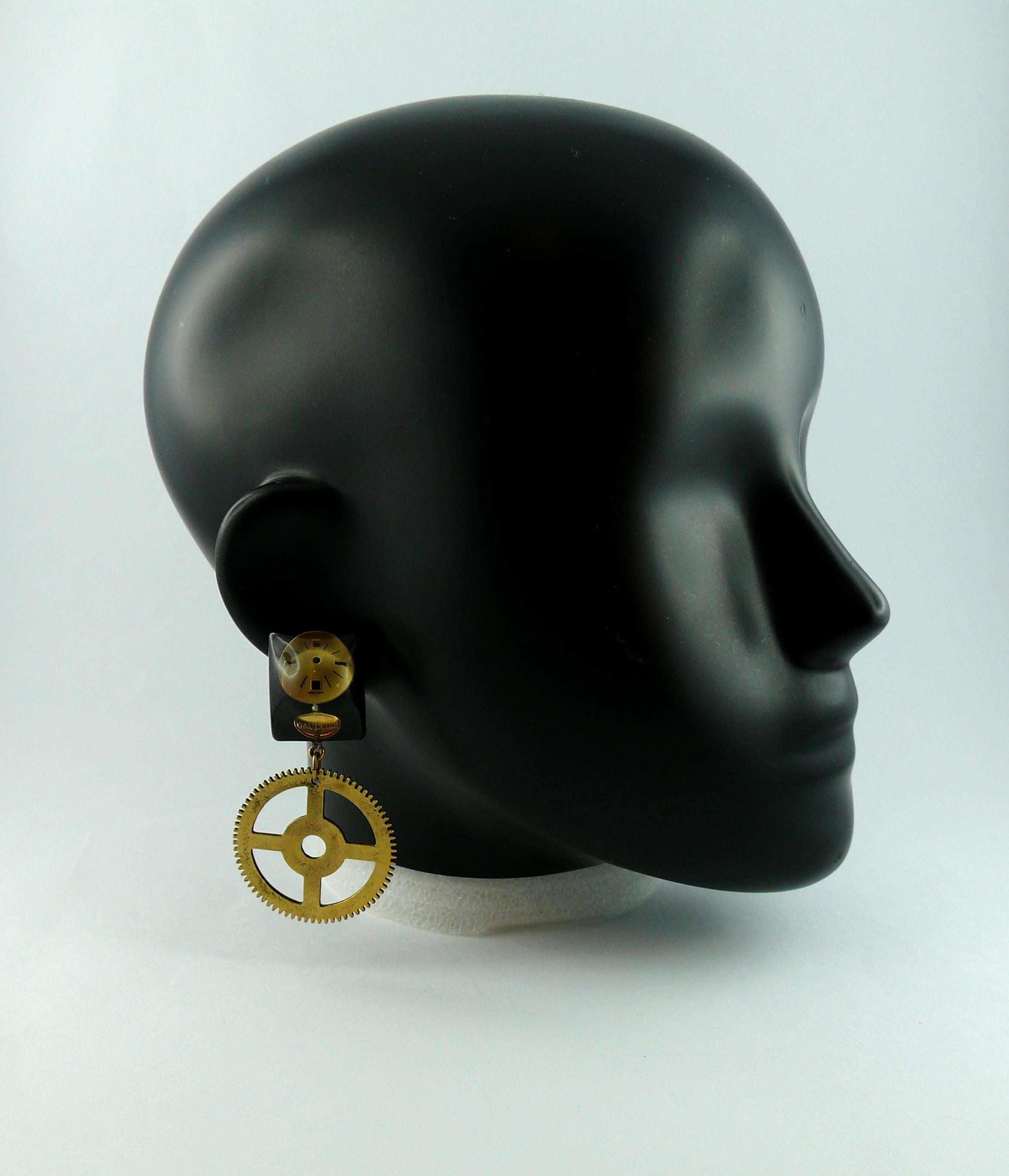JEAN PAUL GAULTIER vintage rare steampunk dangling earrings (clip-on) featuring a resin watch dial inlaid and a gold tone cog.

Marked GAULTIER.

Comes with original dust bag.

JEWELRY CONDITION CHART
- New or never worn : item is in pristine