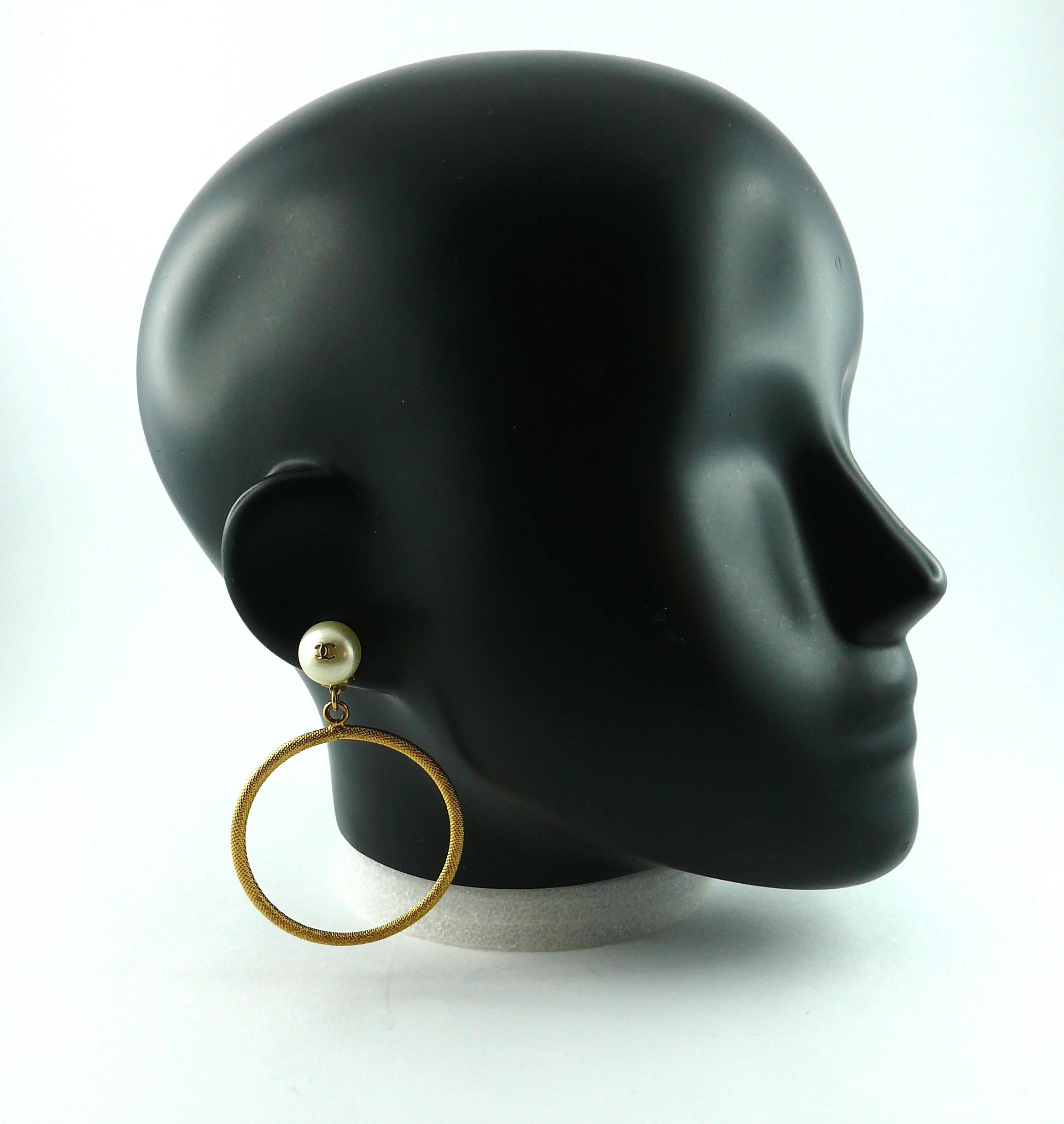 CHANEL vintage jumbo hoop earrings (clip-on) featuring a faux pearl with CC signature logo and a textured gold tone ring.

Embossed CHANEL 97 P Made in France.
Engraved 