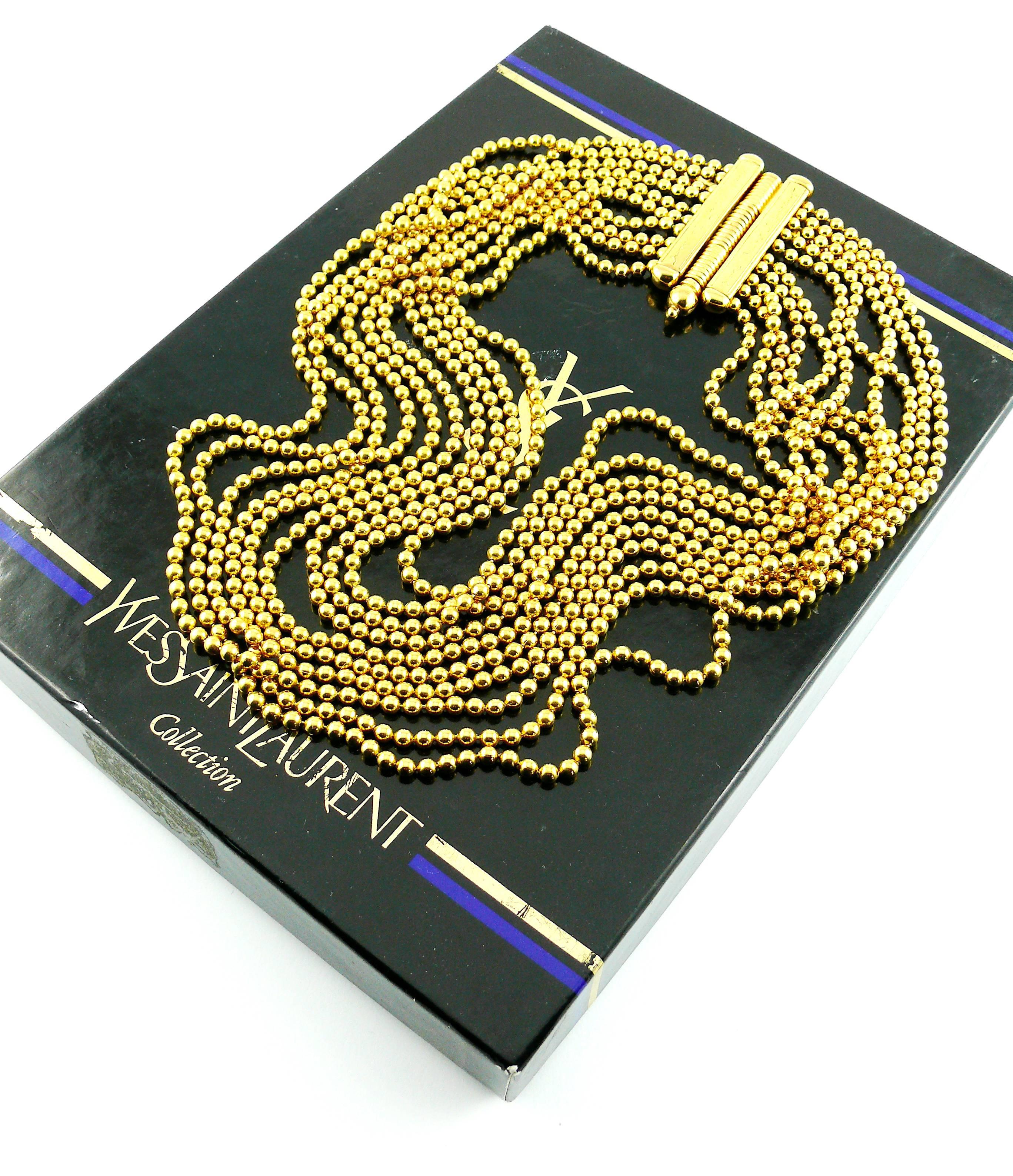 YVES SAINT LAURENT vintage gold toned multi-strand Massaï style necklace.

Secure pin clasp.

Embossed YVES SAINT LAURENT on the clasp.

Indicative measurements : length approx. 44 cm (17.32 inches) / maximum drop (worn) approx. 8 cm (3.15