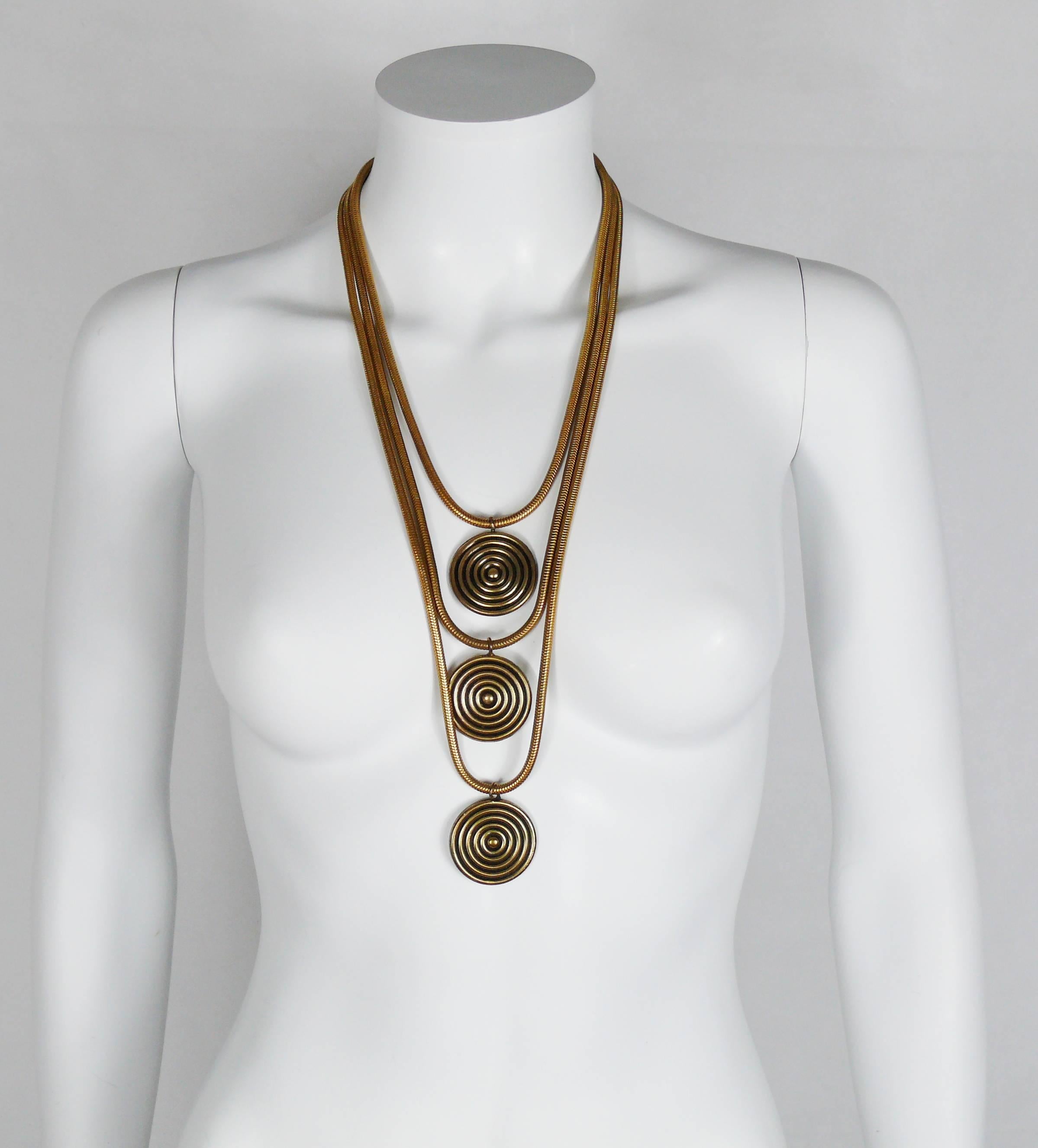 YVES SAINT LAURENT vintage 1970s multi-strand sautoir necklace featuring gold toned snake chains with 3 concentric disc charms.

Hook clasp closure.

Embossed YSL France on the clasp.

Indicative measurements : length approx. 57 cm (22.44 inches) /