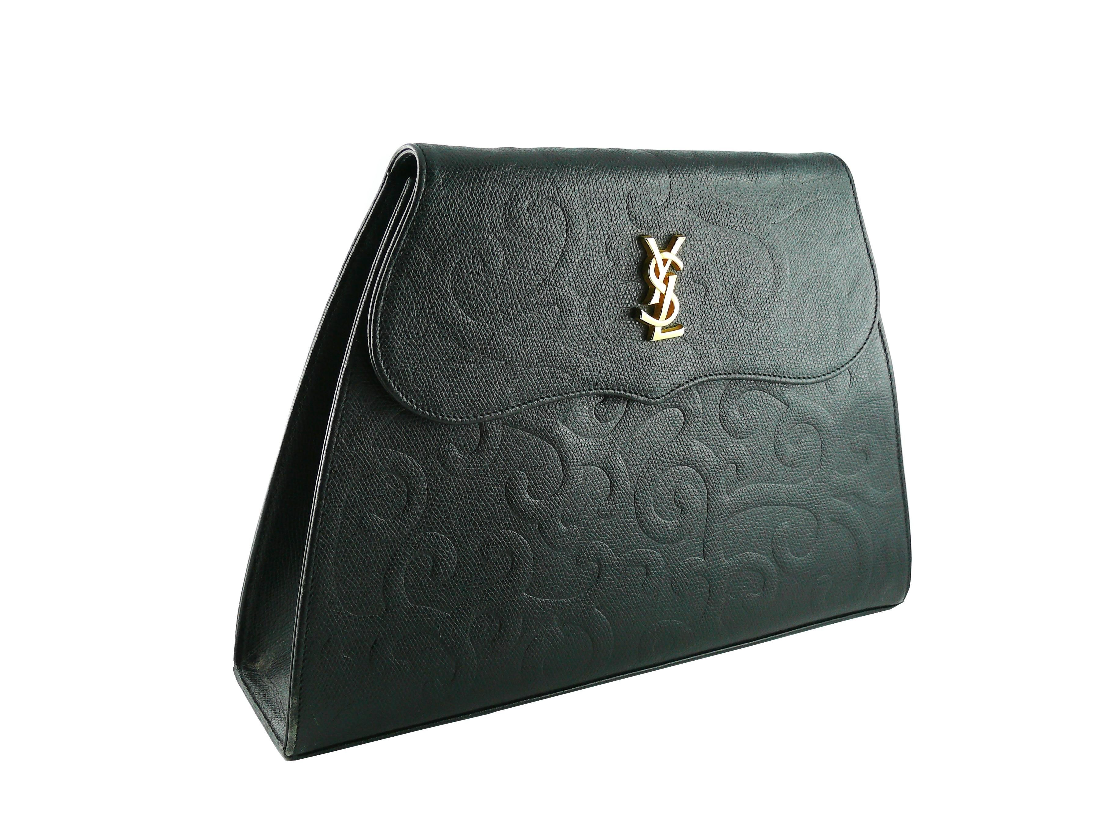 YVES SAINT LAURENT vintage black leather arabesque trapezoidal shoulder bag.

Grained leather featuring a gorgeous embossed arabesque design.

Gold toned YSL monogram logo on the front flap.

Removable shoulder strap that allows this bag to be