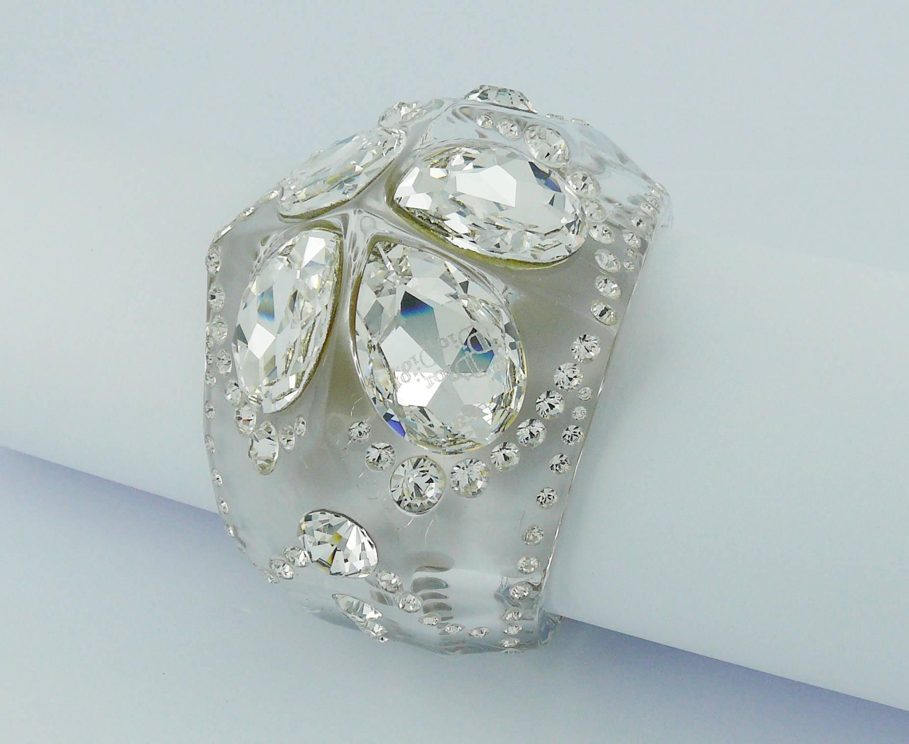CHRISTIAN DIOR clear lucite cuff bracelet embellished with Swarovski crystals.

Engraved Dior on two crystals.

Indicative measurements : inside circumference approx. 17.90 cm (7.05 inches) / width approx. 5.90 cm (2.32 inches) / wrist opening