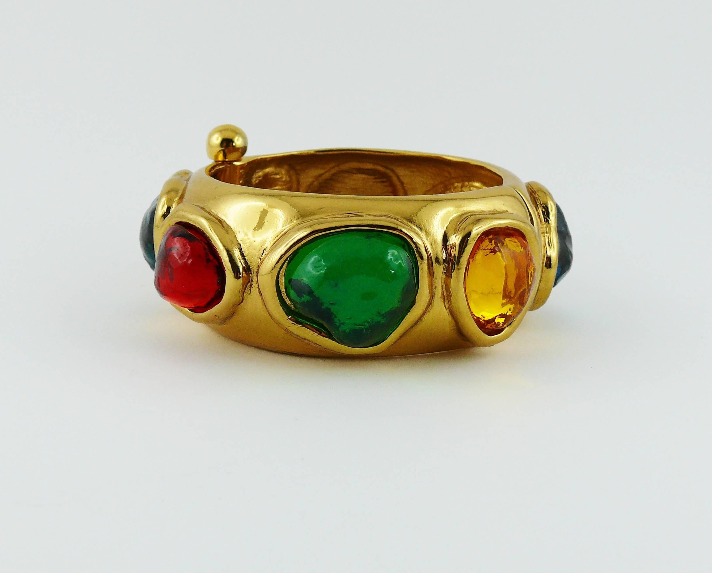 YVES SAINT LAURENT vintage cuff bracelet featuring large multicolored faux gemstone resin cabochons in a gold toned setting.

Embossed YSL Made in France.
Numbered E2.

Indicative measurements : inside circumference approx. 17.9 cm (7.05