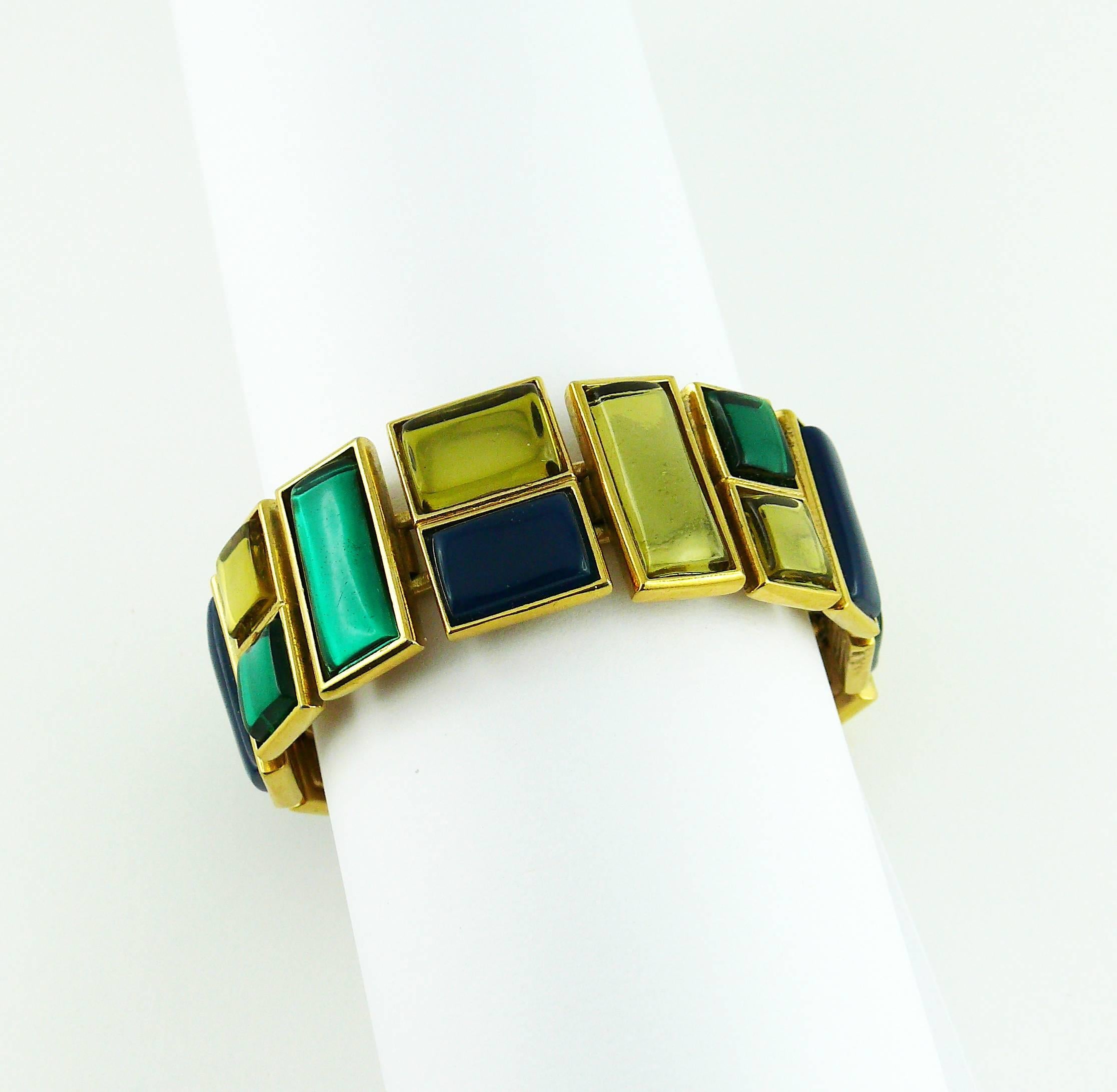YVES SAINT LAURENT vintage Art Deco inspired geometric articulated bracelet featuring rectangular and square multi colored resin cabochons.

Embossed YSL Made in France.

Indicative measurements : length approx. 17.3 cm (6.81 inches) / width approx.