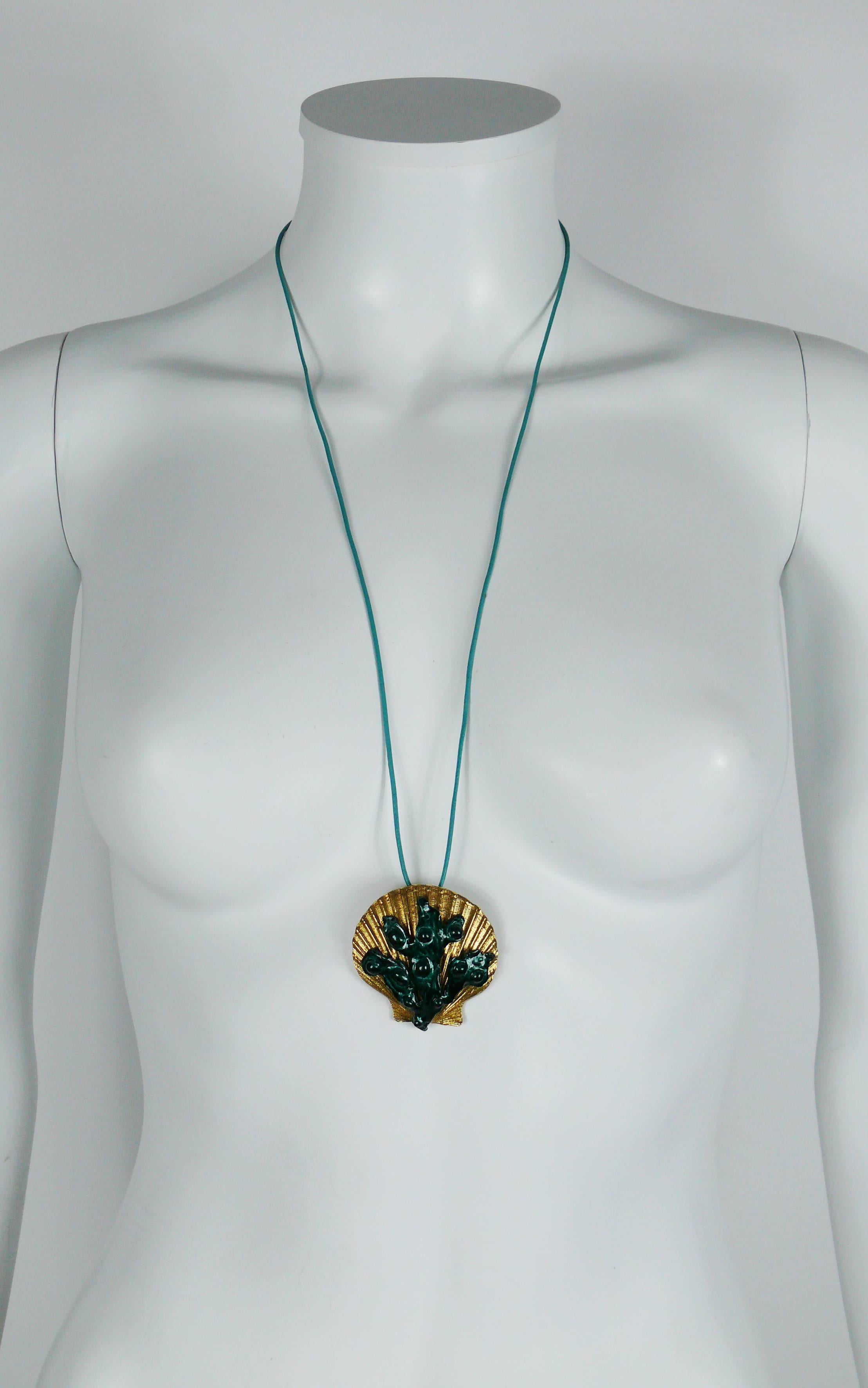 YVES SAINT LAURENT vintage pendant/brooch featuring a gold tone shell embellished with a green enameled seaweed appliqué.

Comes with a lagoon blue color thin leather cord (length worn approx. 29 cm / 11.42 inches).

Can be worn as a brooch or