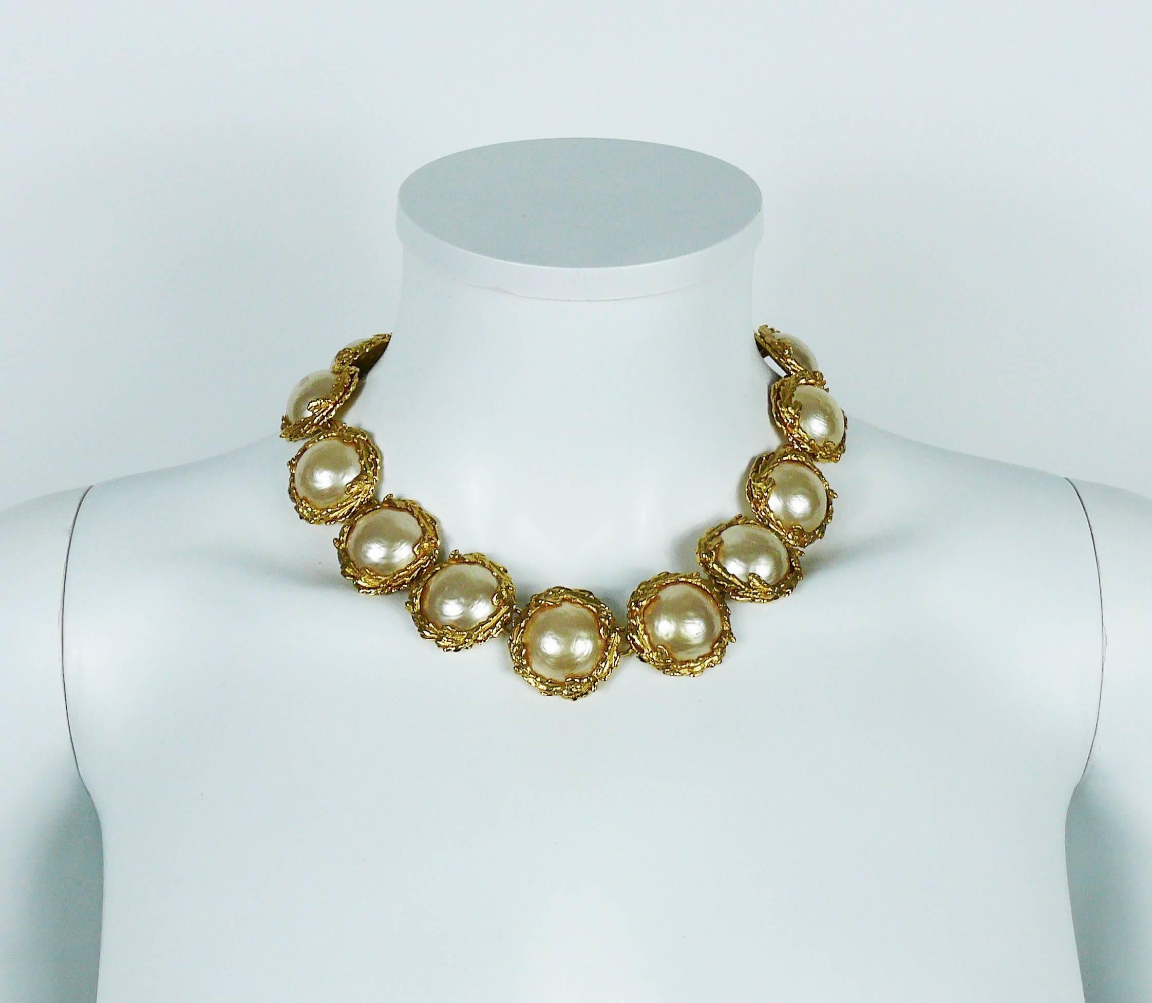 YVES SAINT LAURENT vintage necklace and earrings (clip-on) set embellished with large irregular half faux pearls in a gold toned foliage setting.

NECKLACE
Marked Marked YVES SAINT LAURENT Made in France.
Indicative measurements : max. length