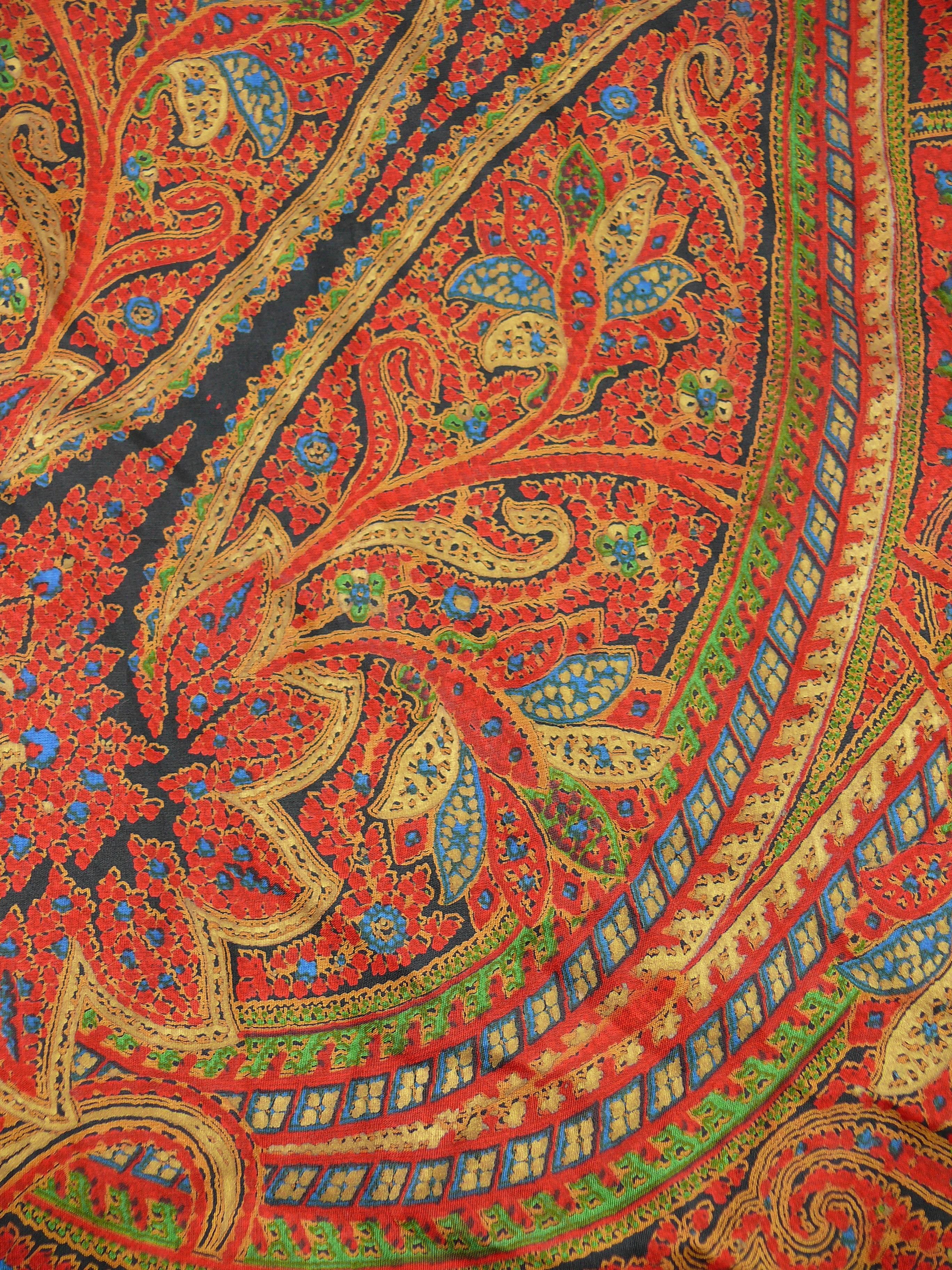 YVES SAINT LAURENT wunderschöner Vintage-Schal mit Fransen und einem opulenten, orientalisch inspirierten Design in den Farben Rot, Blau, Grün, Safran, Schwarz und Gold.

Lange schwarze Fransen rundherum.

Bedruckte YSL.

Zusammensetzungs- und