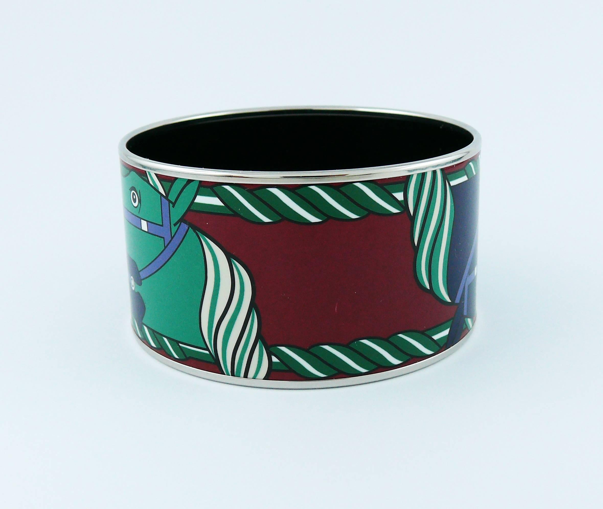 HERMES extra wide printed enamel bracelet featuring a stylized equestrian design in blue, green and white on a burgundy red background.

Palladium plated rims.

Marked HERMES Paris.
Made in France + N.

"S" mark for private sale -
