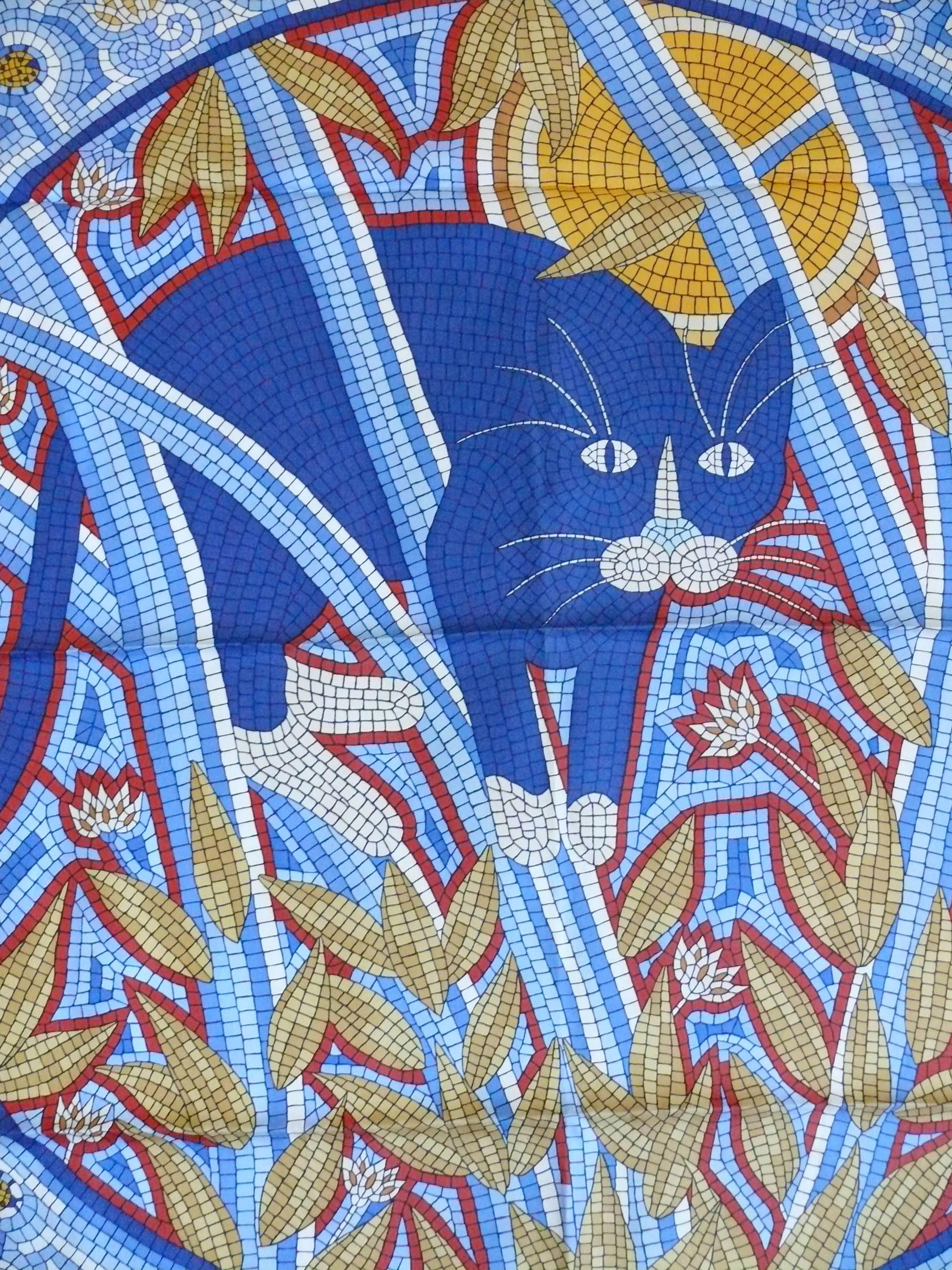 HERMES silk carré "Cave Felem" featuring a muticolored mosaic design with a cat hunting for mice.

Designed by CHRISTINE HENRY.

Issued in 1998.

This scarf features :
- Hand rolled borders.
- Crispy silk.
- Plump hems.
- 100 % silk.
-
