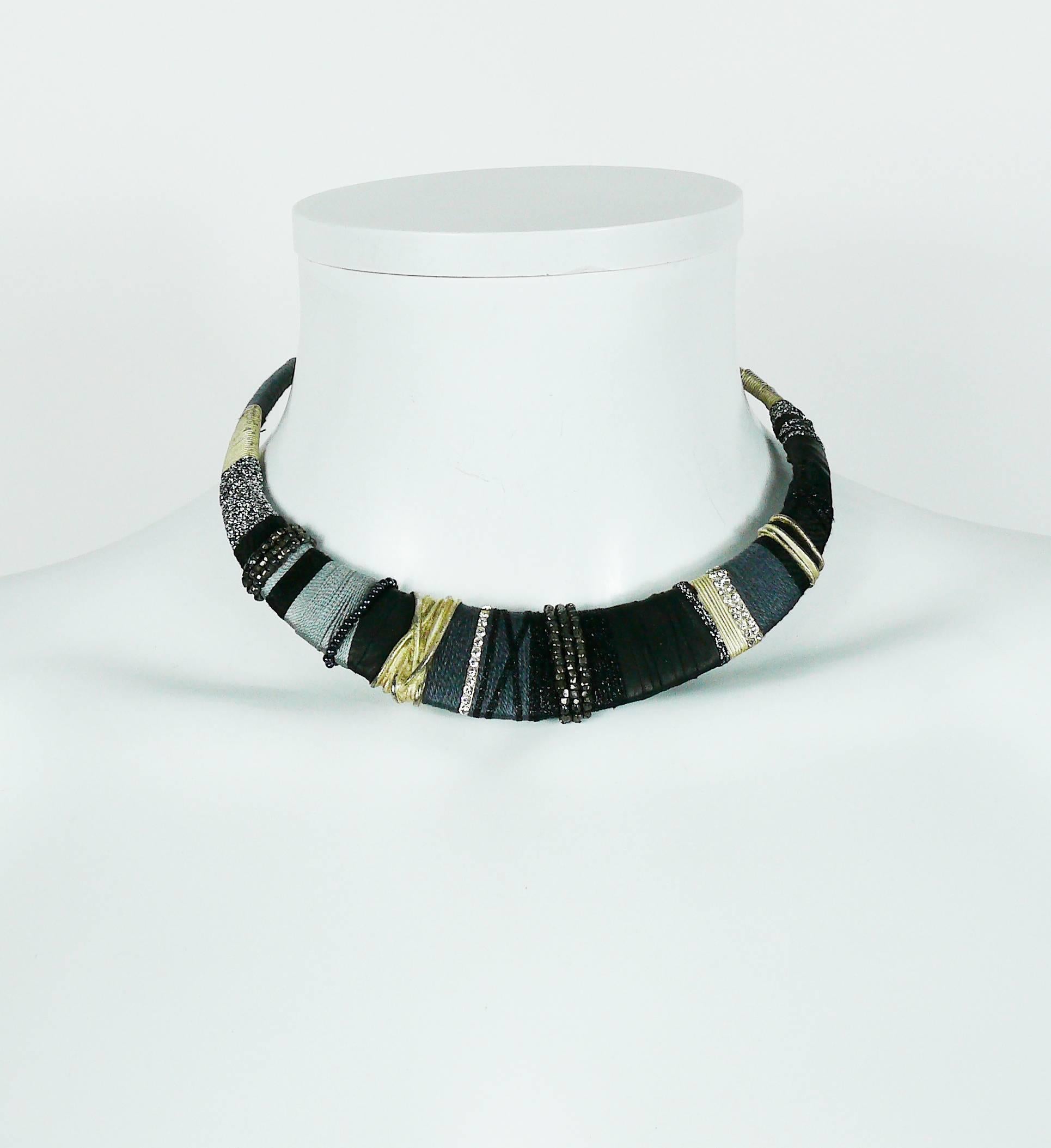 CHRISTIAN LACROIX vintage Masai inspired silver toned rigid choker necklace embellished with grey and black pearls, fabrics, black leather and clear crystals.

Hook clasp.

Marked CHRISTIAN LACROIX CL Made in France.

Indicative measurements : inner
