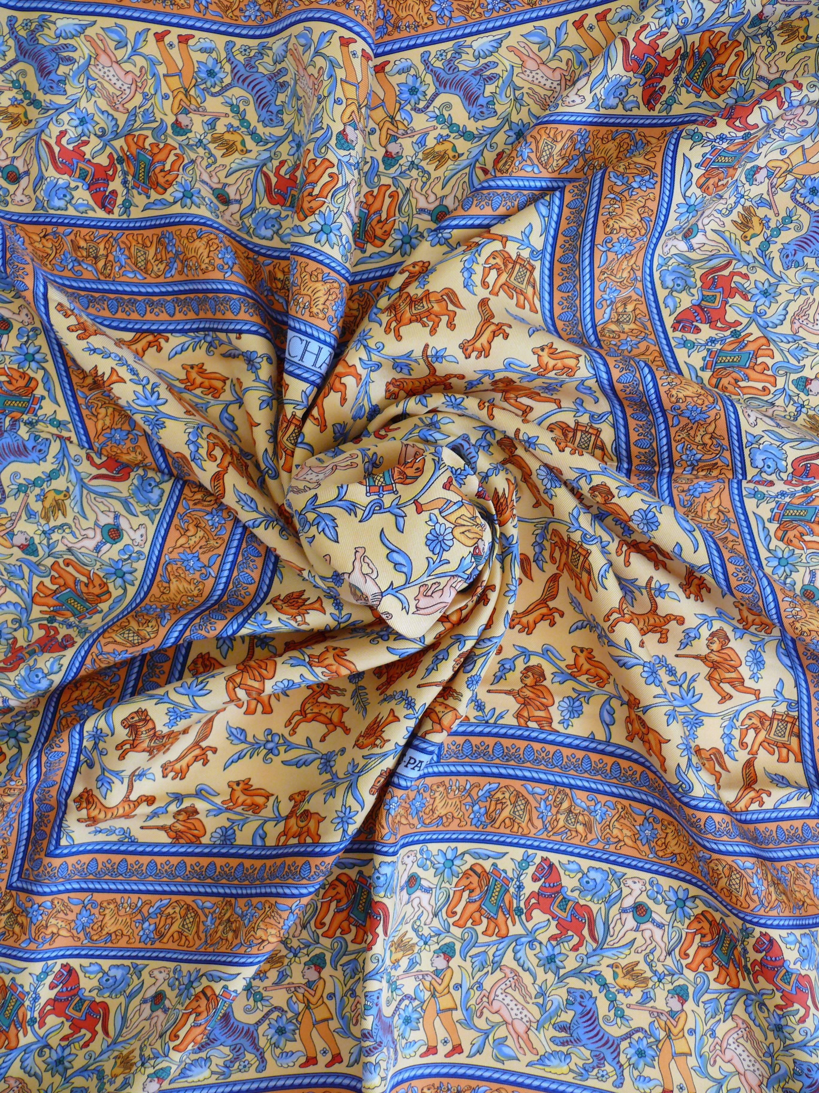 HERMES silk carré "Chasse en Inde" with an opulent muticolored design featuring exotic animals, hunters, horses and flowers.

Designed by MICHEL DUCHENE.

This scarf features :
- Hand rolled borders.
- Plump hems.
- 100 % silk.
-