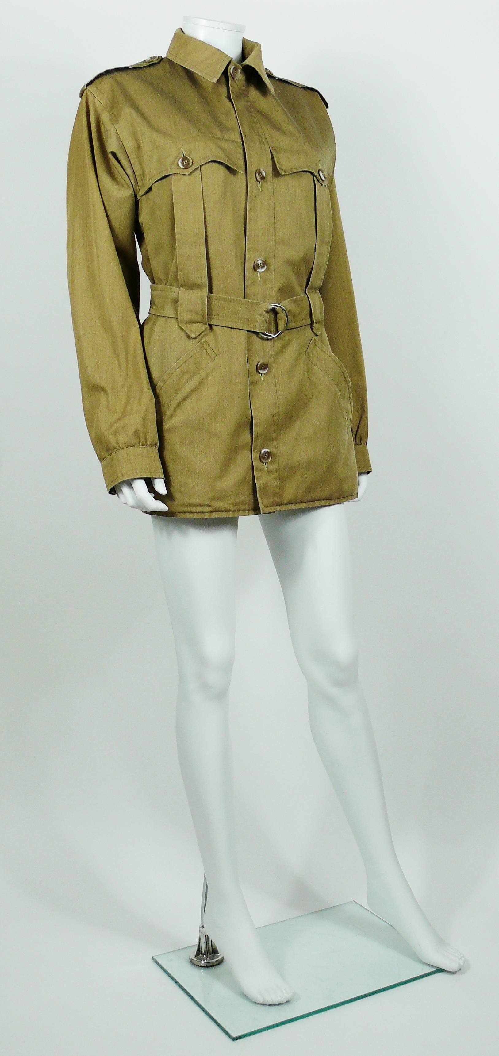 YVES SAINT LAURENT vintage safari jacket.

This jacket features :
- Two patch pockets on breast.
- Two pockets on hips.
- Long sleeves.
- Adjustable belt with silver toned rings buckle.
- Front buttoning.
- Buttoning sleeves.
- Epaulettes.

Label