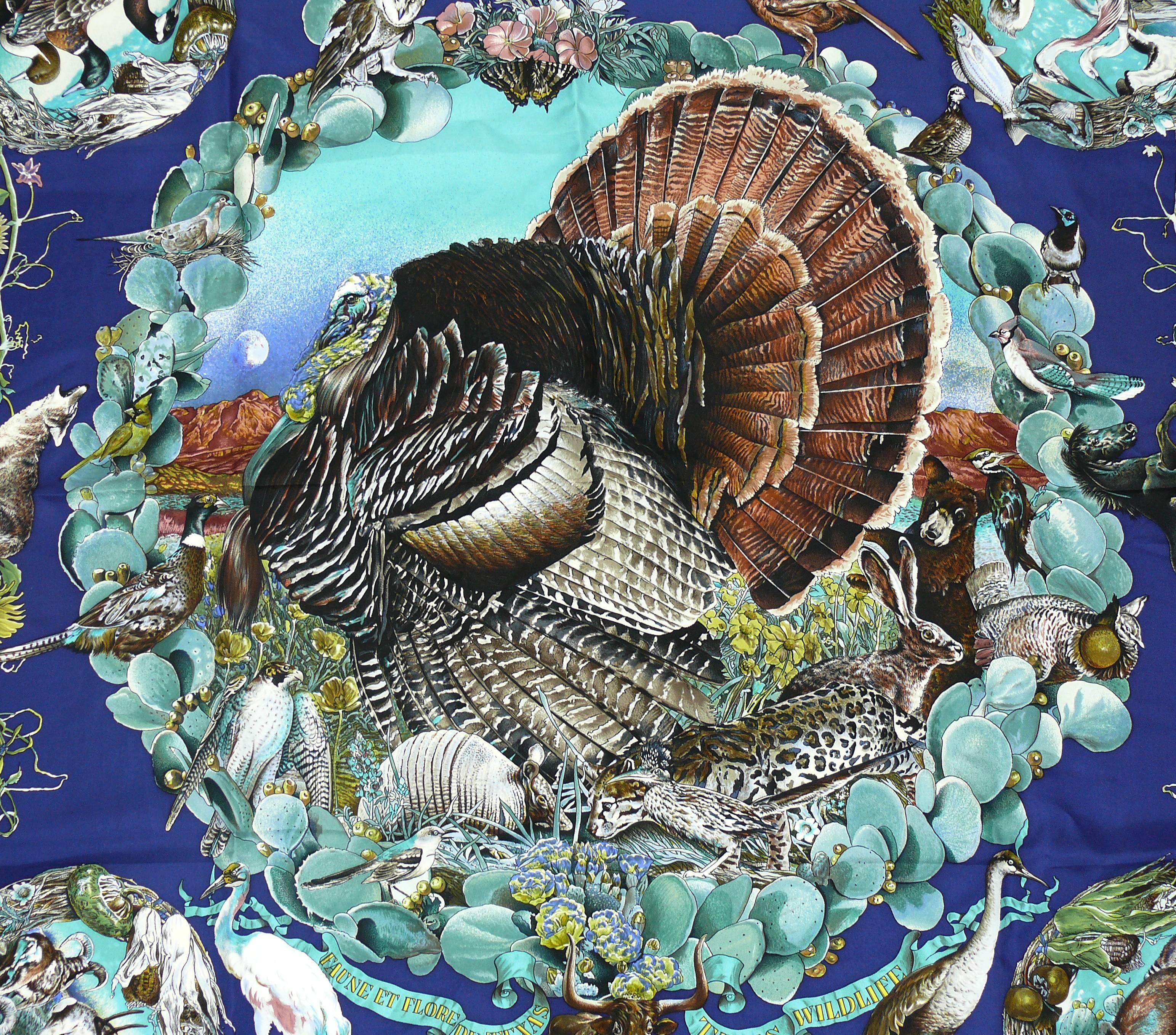 HERMES rare silk carre scarf "Faune et Flore du Texas" (Texas Wildlife) designed by native Texan KERMIT OLIVER in gorgeous colors on a blue background. Black borders.

This scarf features :
- Hand rolled borders.
- Plump hems.
- 100 %