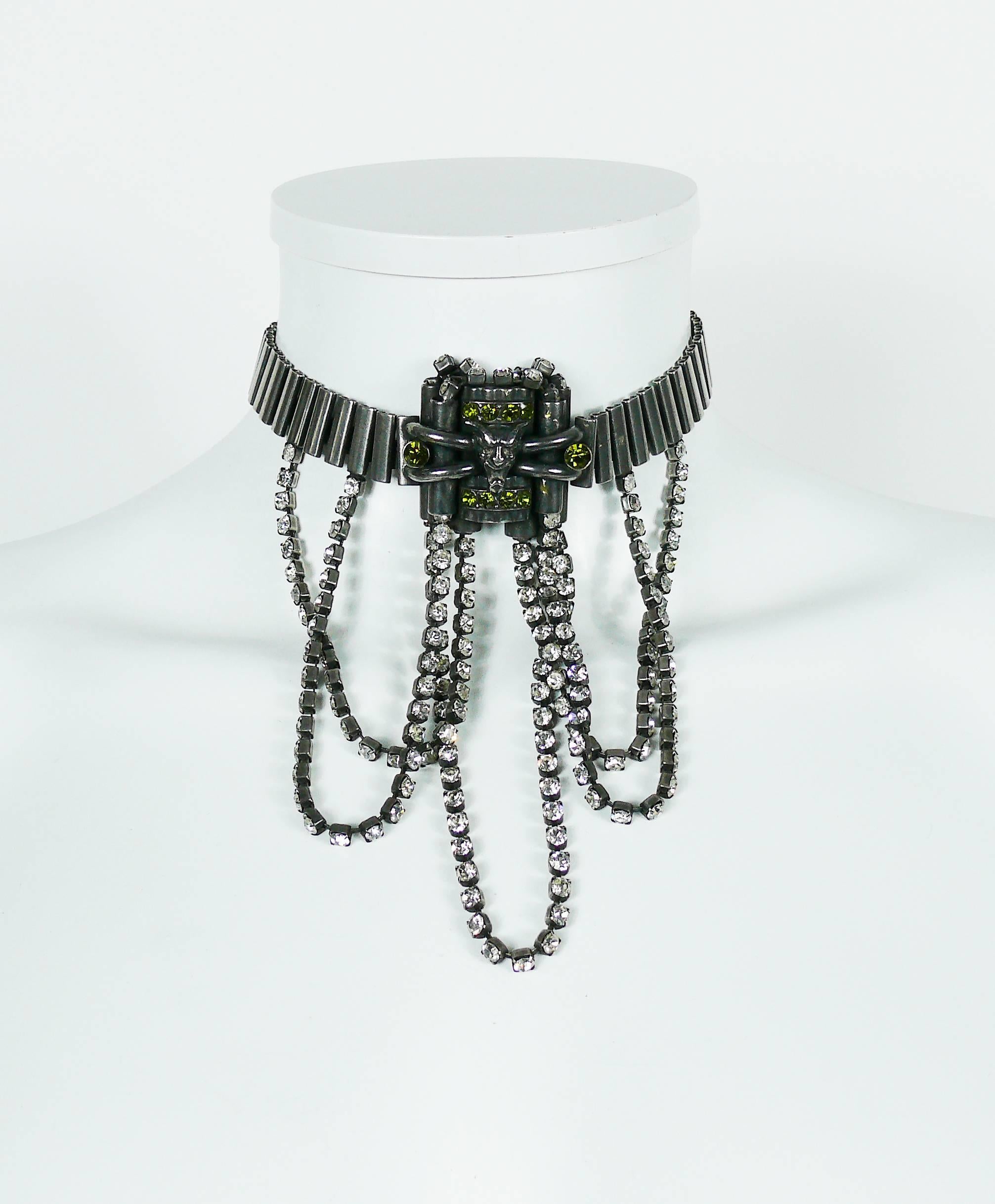 JEAN PAUL GAULTIER vintage gun patina dog collar necklace featuring cascading clear crystal chains, green crystals and demon mask at center.

Lobster clasp closure.
Extension chain.

Unmarked.
Matching signed clip-on earrings available on our