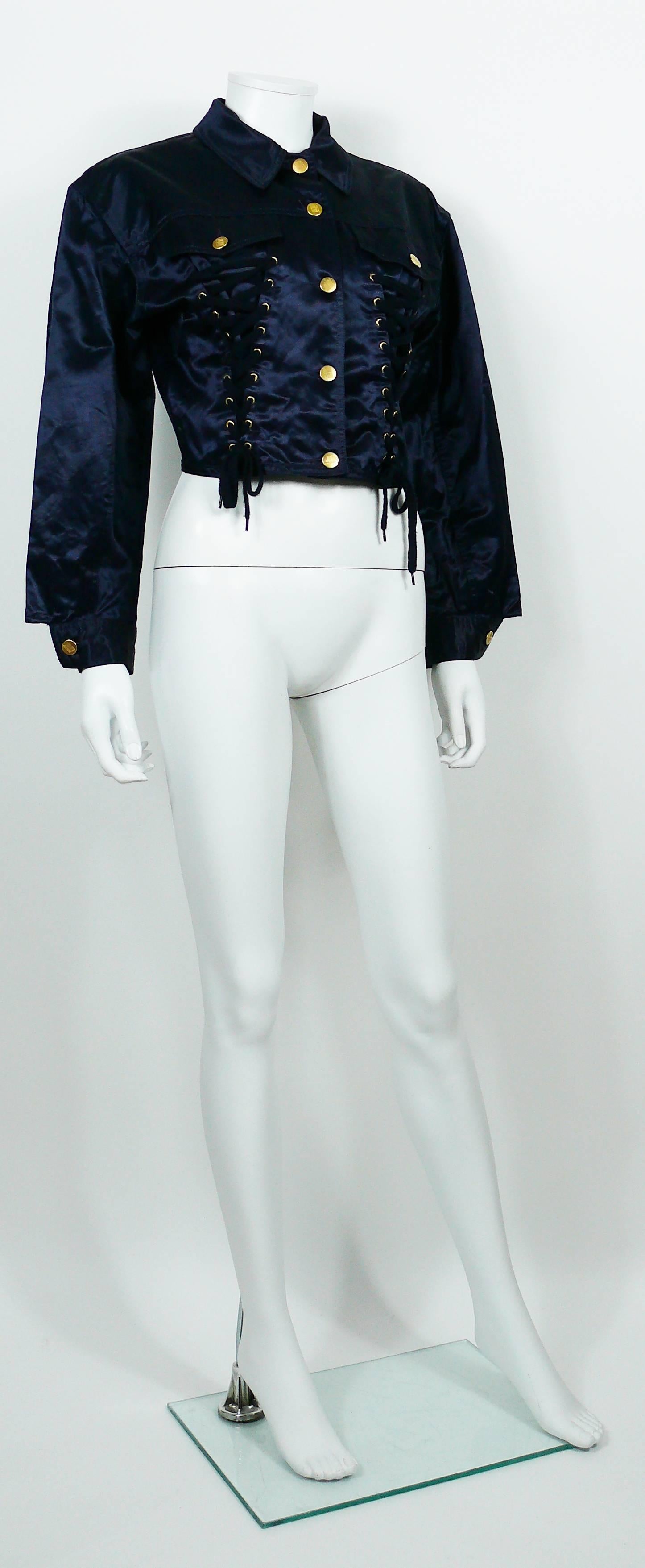 JEAN PAUL GAULTIER Junior vintage navy blue coated cotton iconic corset style jacket.

This jacket features classic collar, front button fastening, front lace up detail, long sleeves with button cuffs and pocket detail at the chest.

Label reads