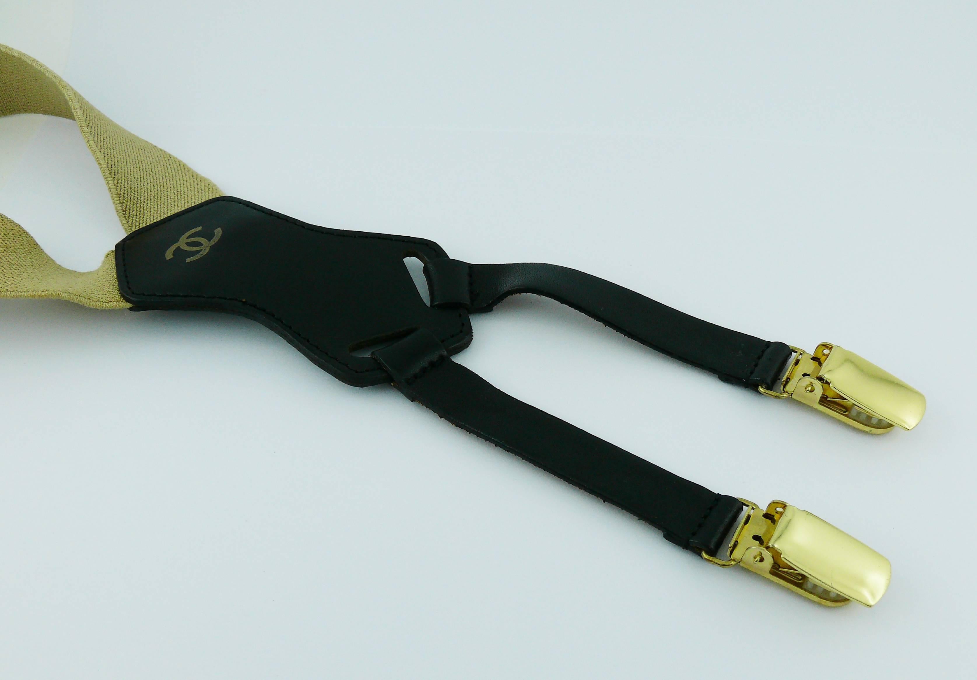 Chanel vintage iconic rare suspenders in light brown version with black printed lettering, gold toned hardware and leather trim.

CC logo printed on the leather.
Label "Fabriqué en France" (Made in France) on the reverse.

These iconic