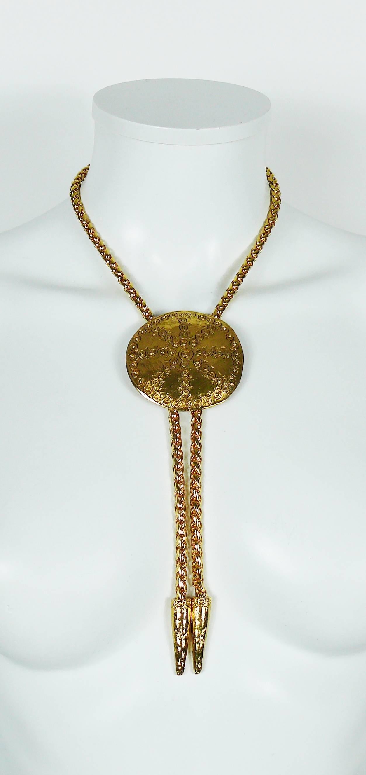 YVES SAINT LAURENT vintage gold toned lariat necklace featuring a large ethnic disc.

The height of the disc is adjustable.

Embossed YSL Made in France.

Indicative measurements : max. length worn (including tassels) approx. 33 cm (12.99 inches) /
